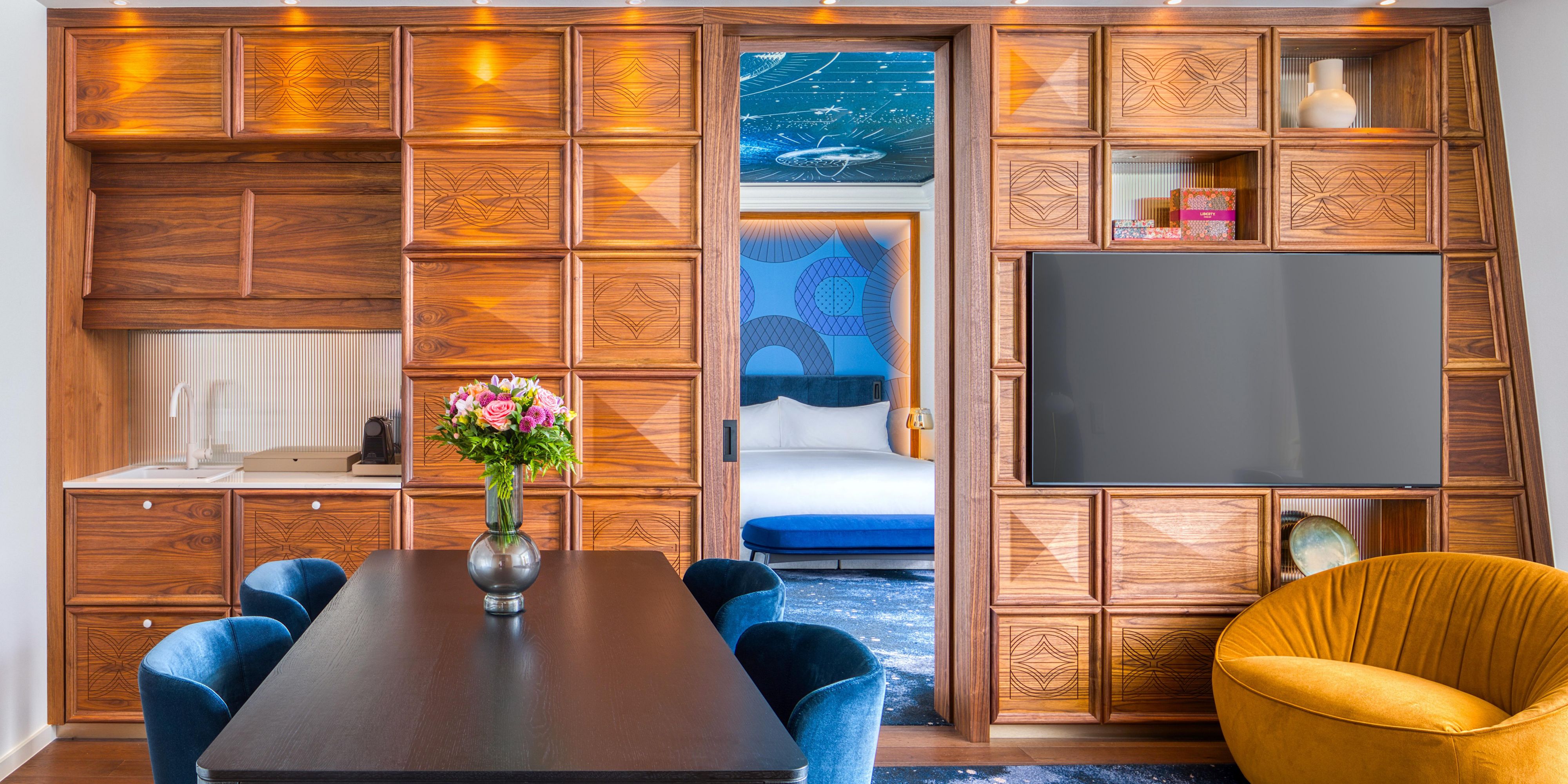 Living room with a dining area in the Cosmos Suite
