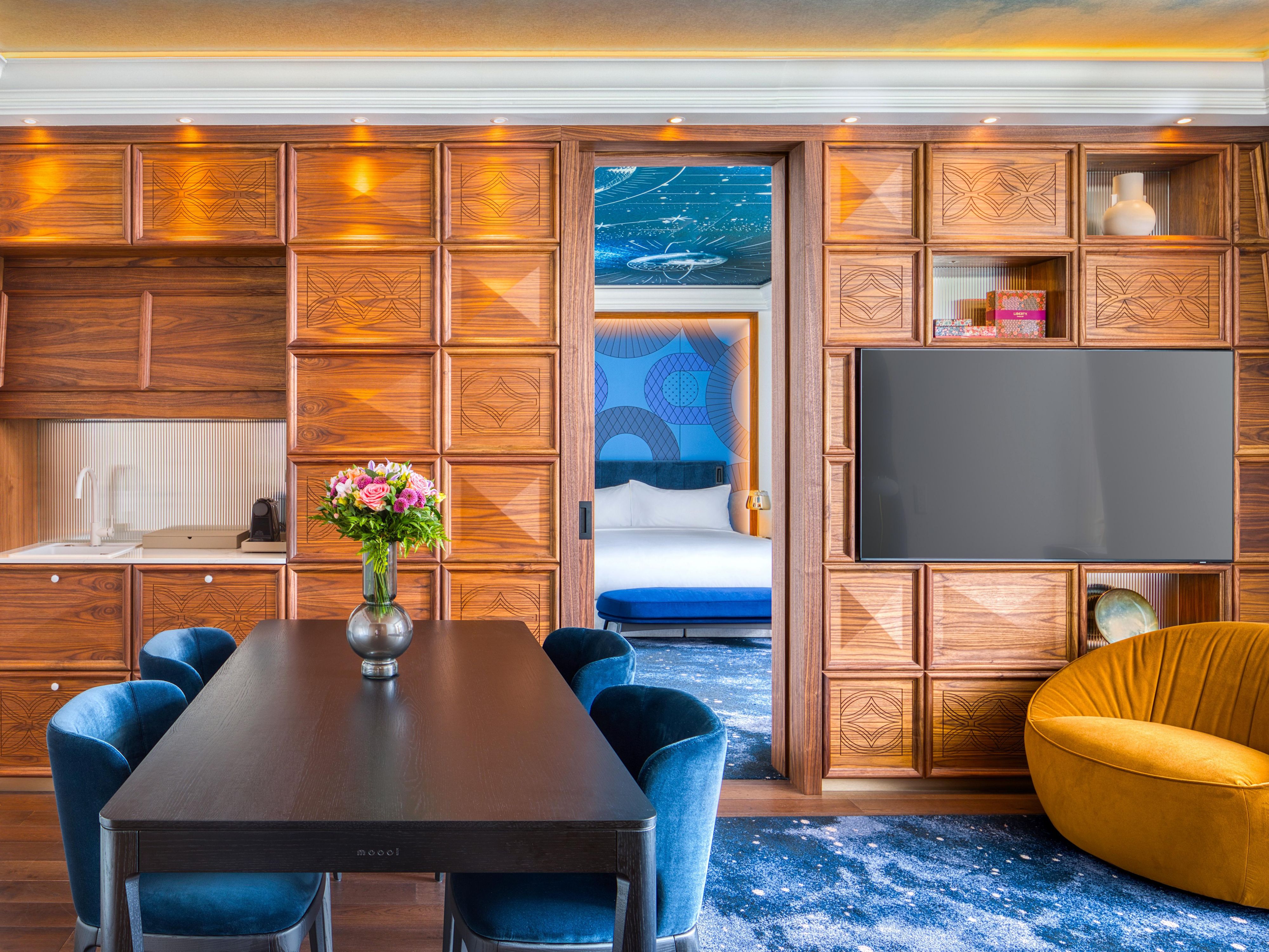 Living room with a dining area in the Cosmos Suite