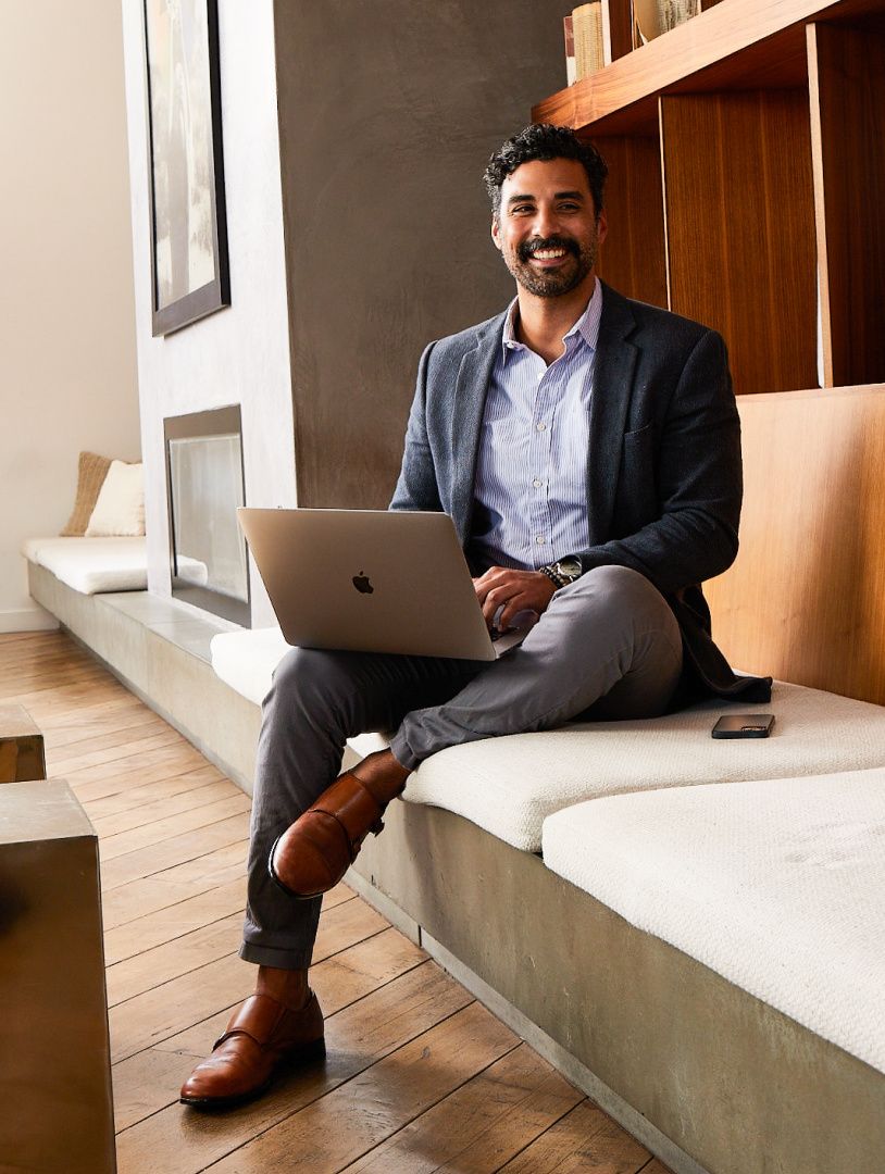 business traveler in lobby of hotel with laptop