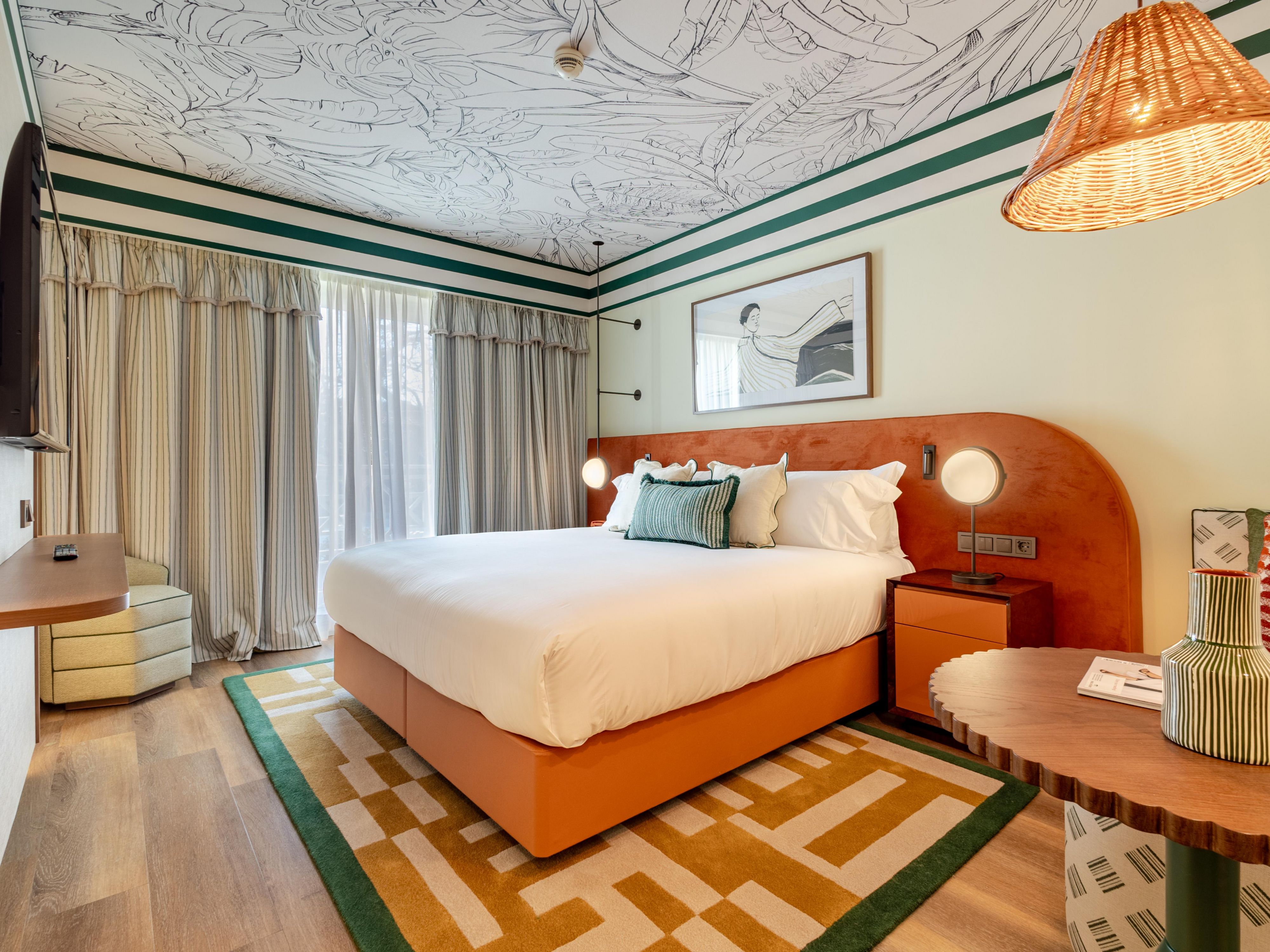 Elegant hotel room with king bed and warm contemporary design