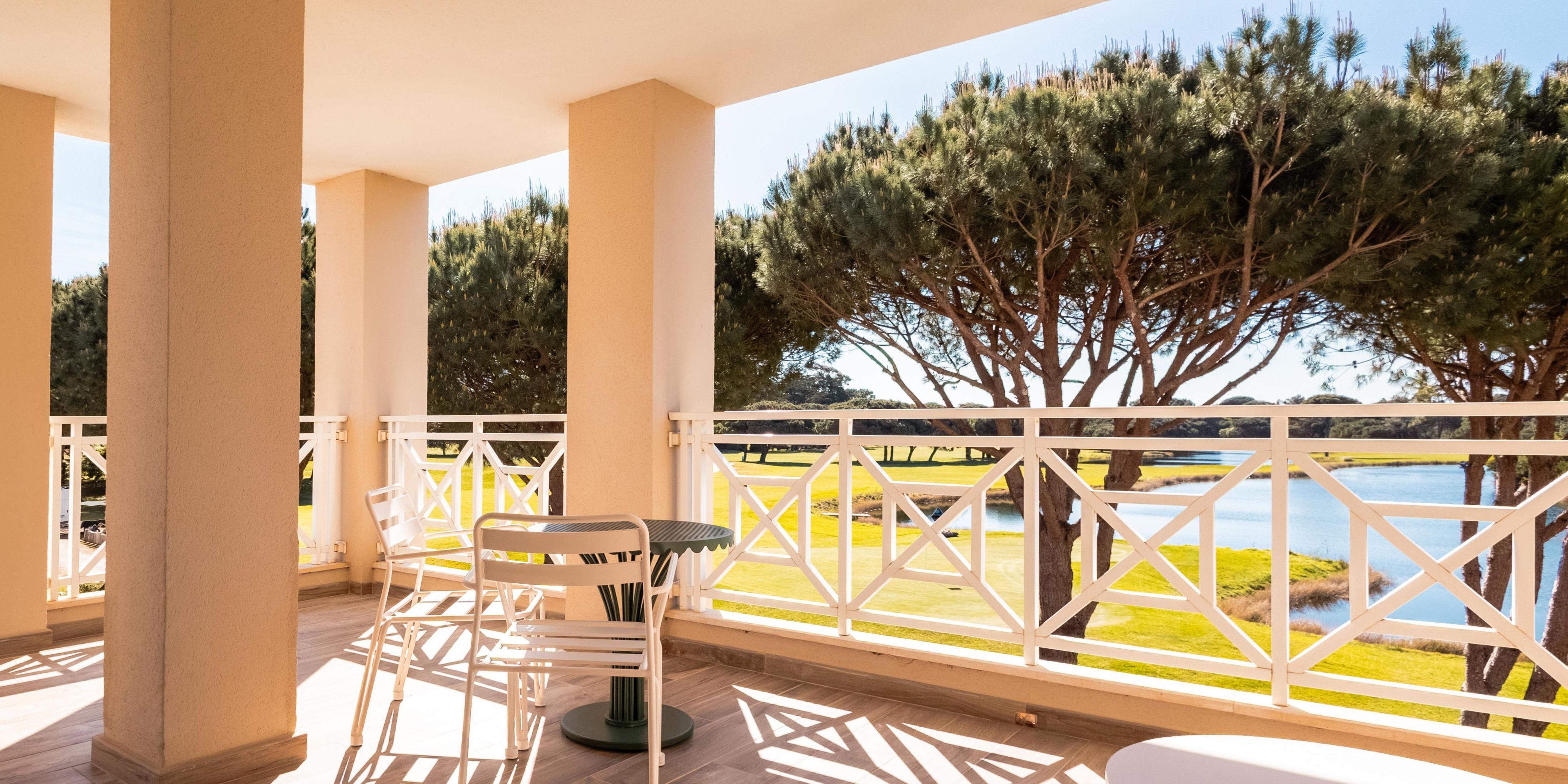 Outdoor terrace with lounge and lake view.