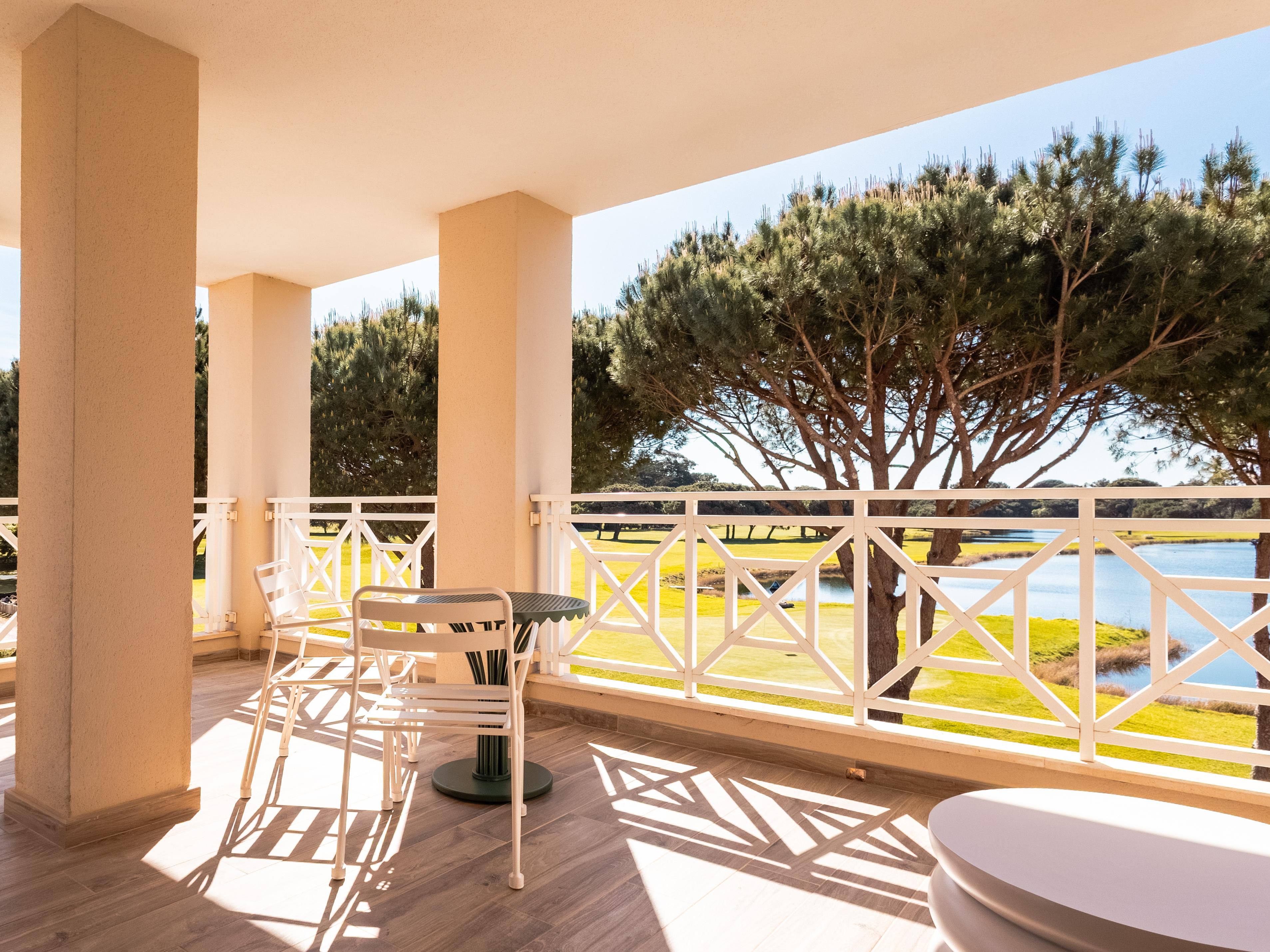 Outdoor terrace with lounge and lake view.
