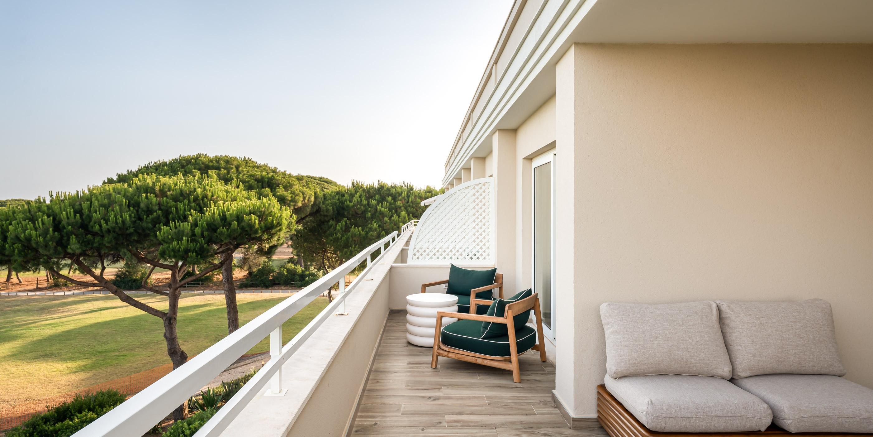 Outdoor terrace with lounge area and a view of nature.