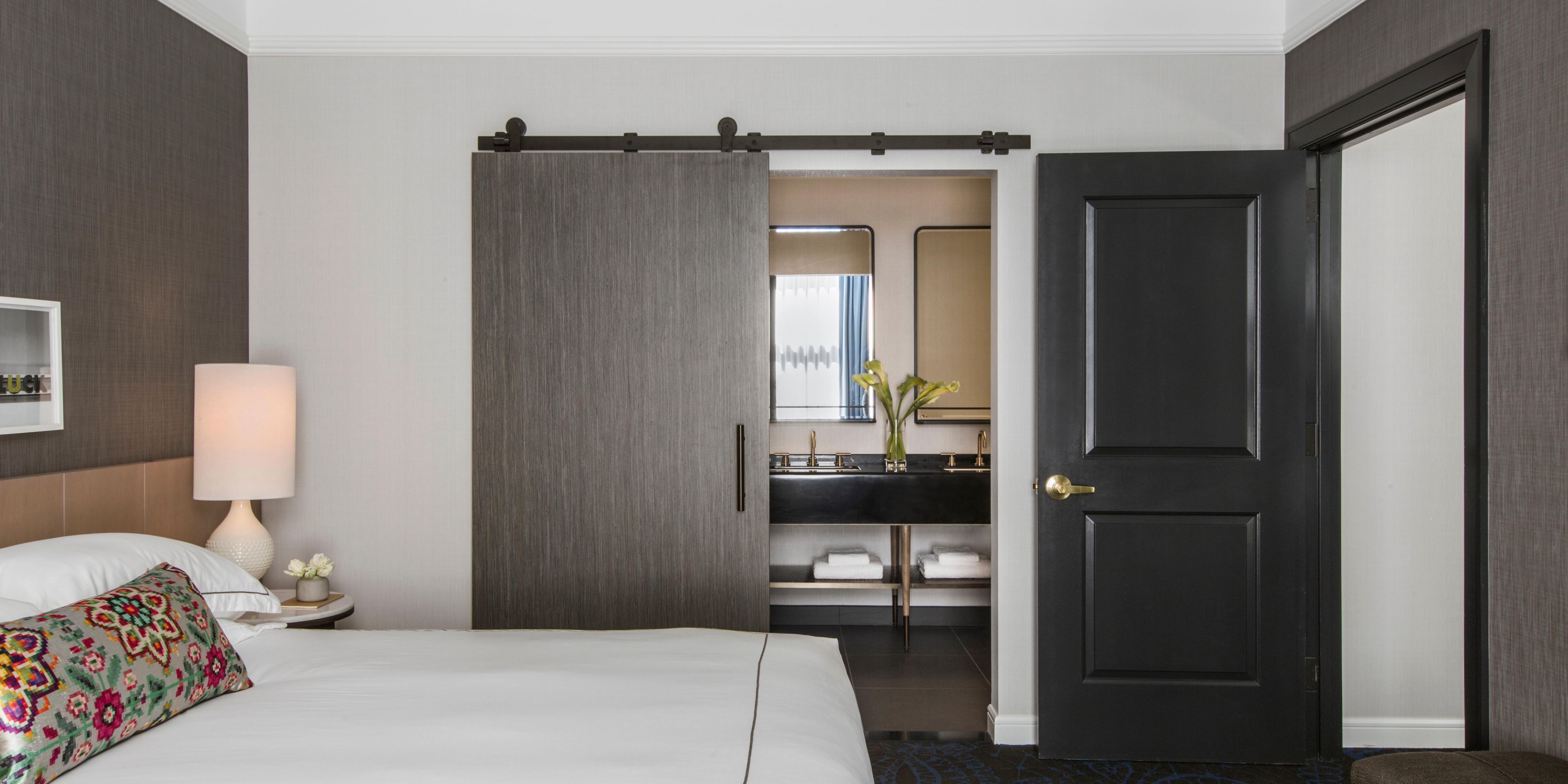 Sliding barn doors open to spa style bathrooms.