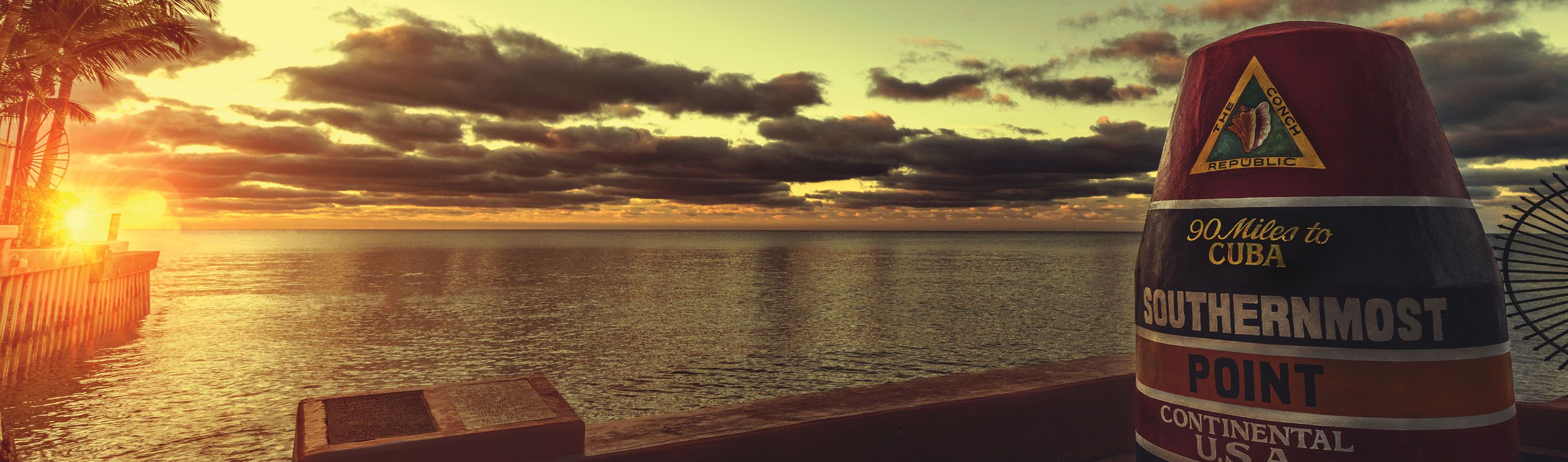 view from the peir looking out over the ocean at sunset 