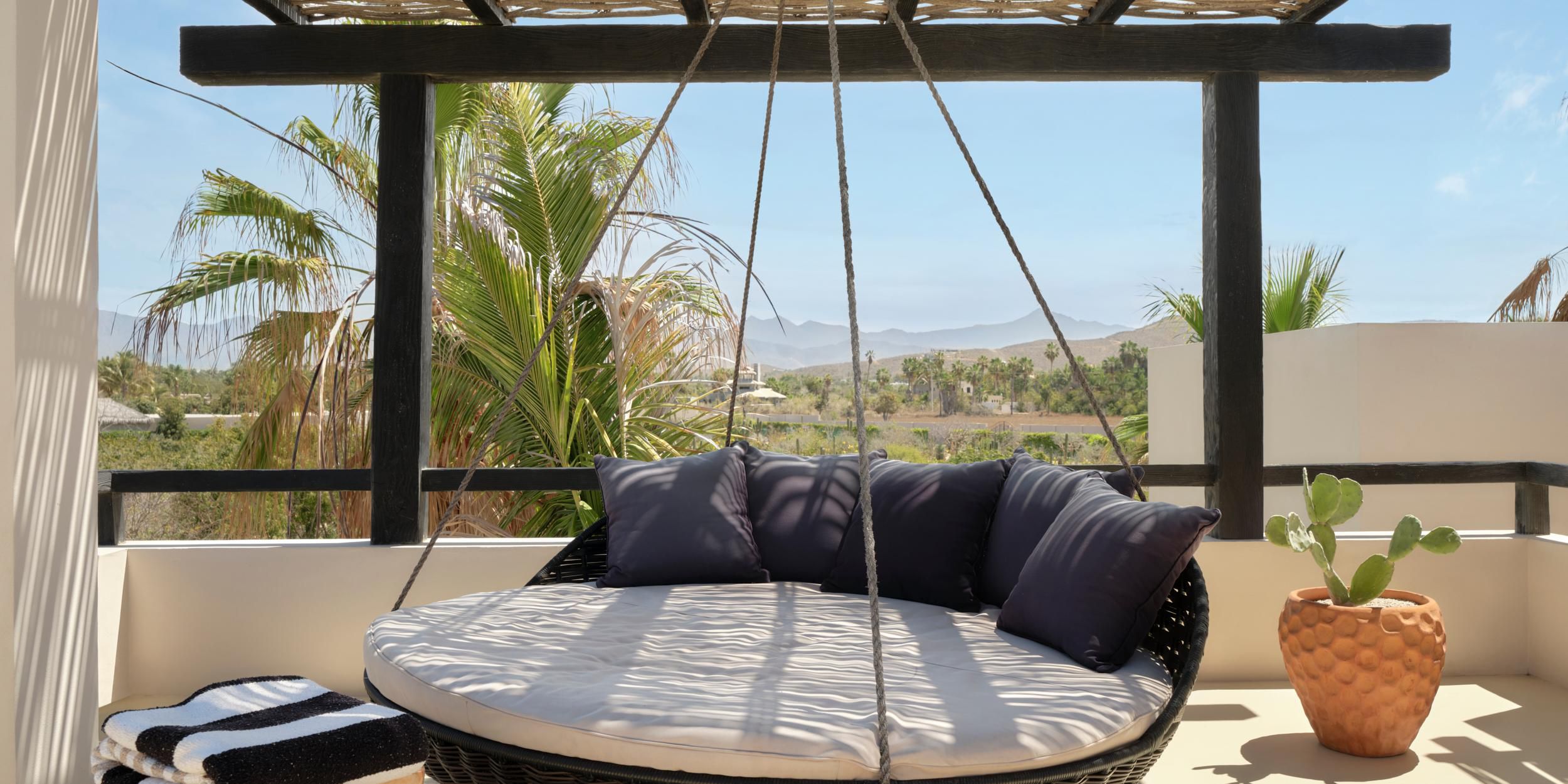 A shaded hanging daybed invites total relaxation outdoors.