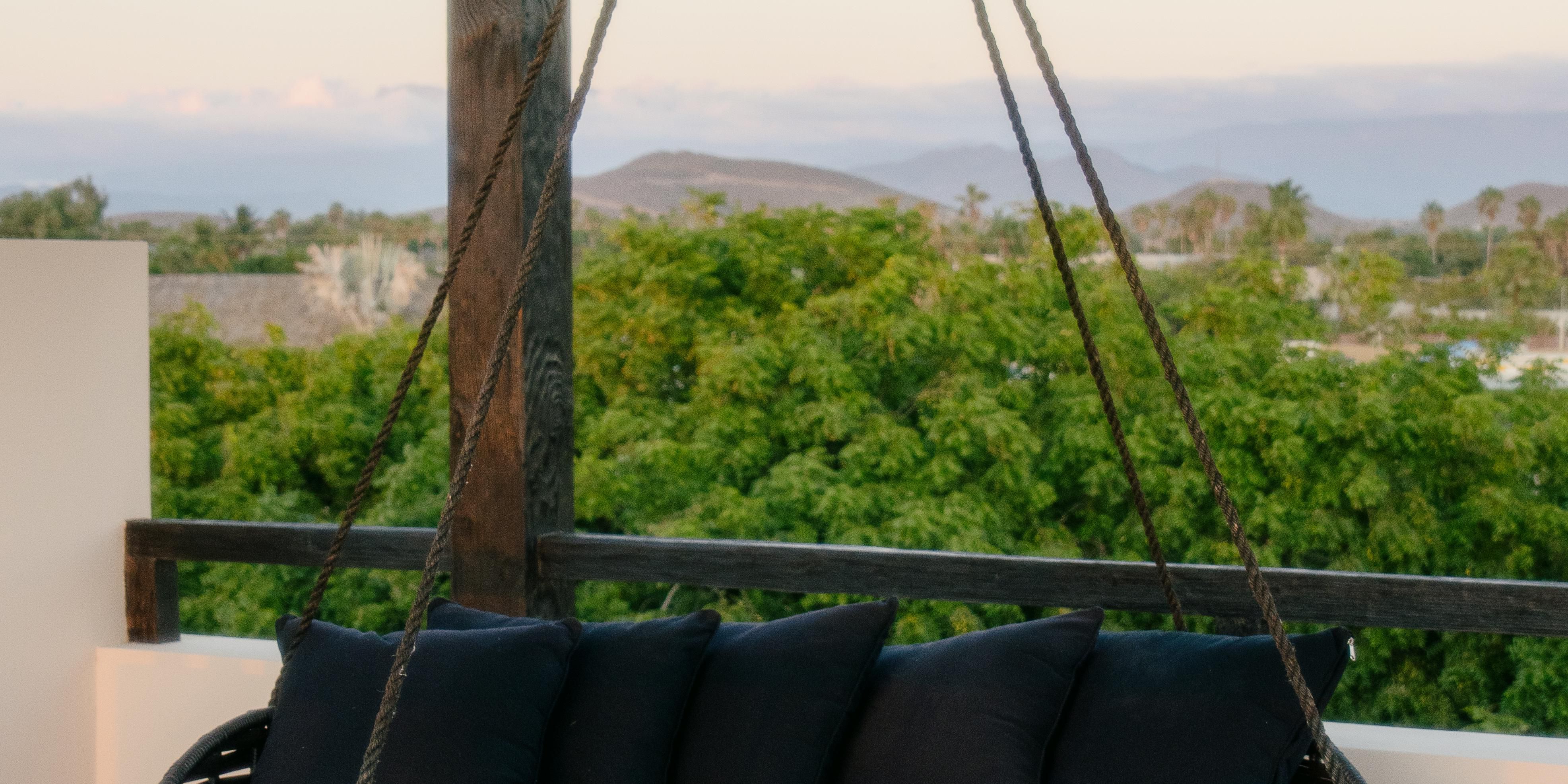 Hanging daybed styled for serene, open‑air lounging.