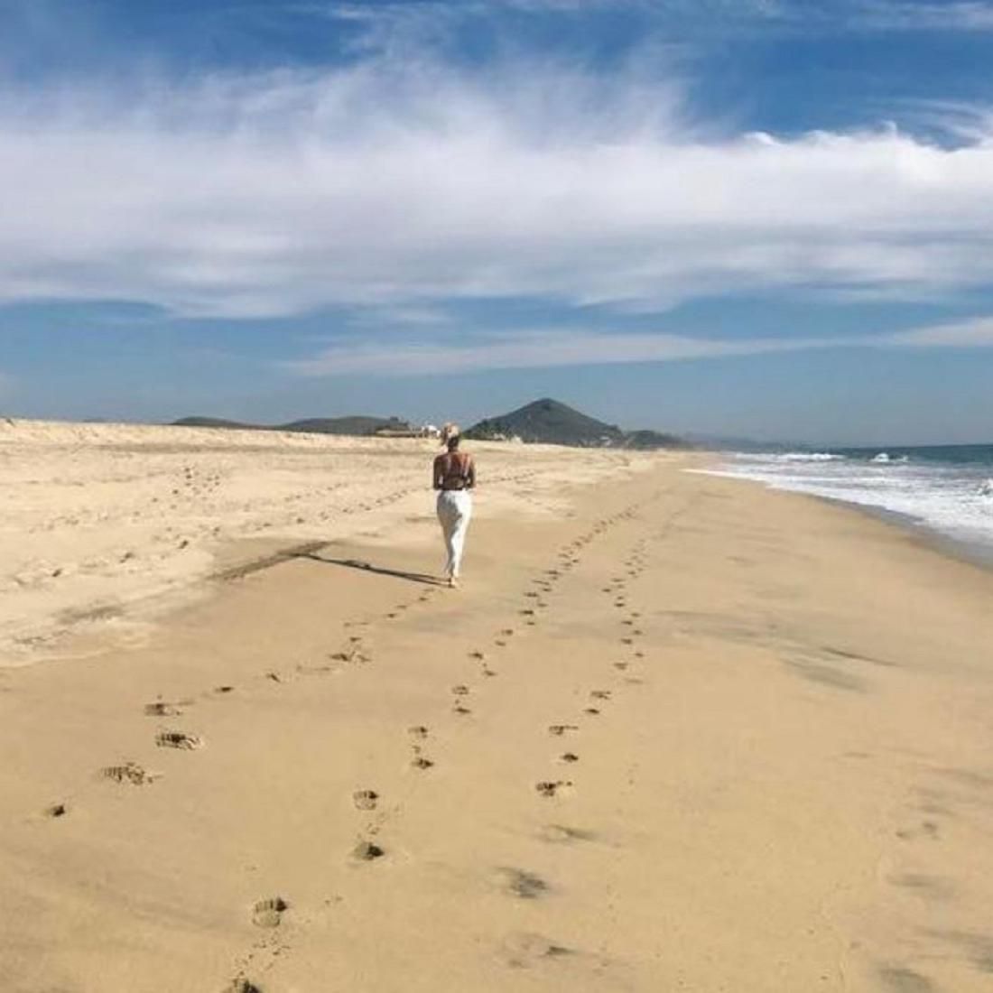 Woman walking on the beach.