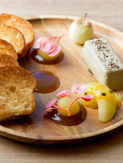 Decoratively plated breakfast food on wooden plate