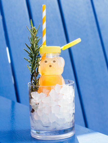 a honey bear cocktail in a glass of ice