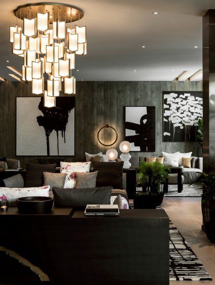 Camera d'albergo di fascia alta con arredi grigi ed elegante lampadario a bracci