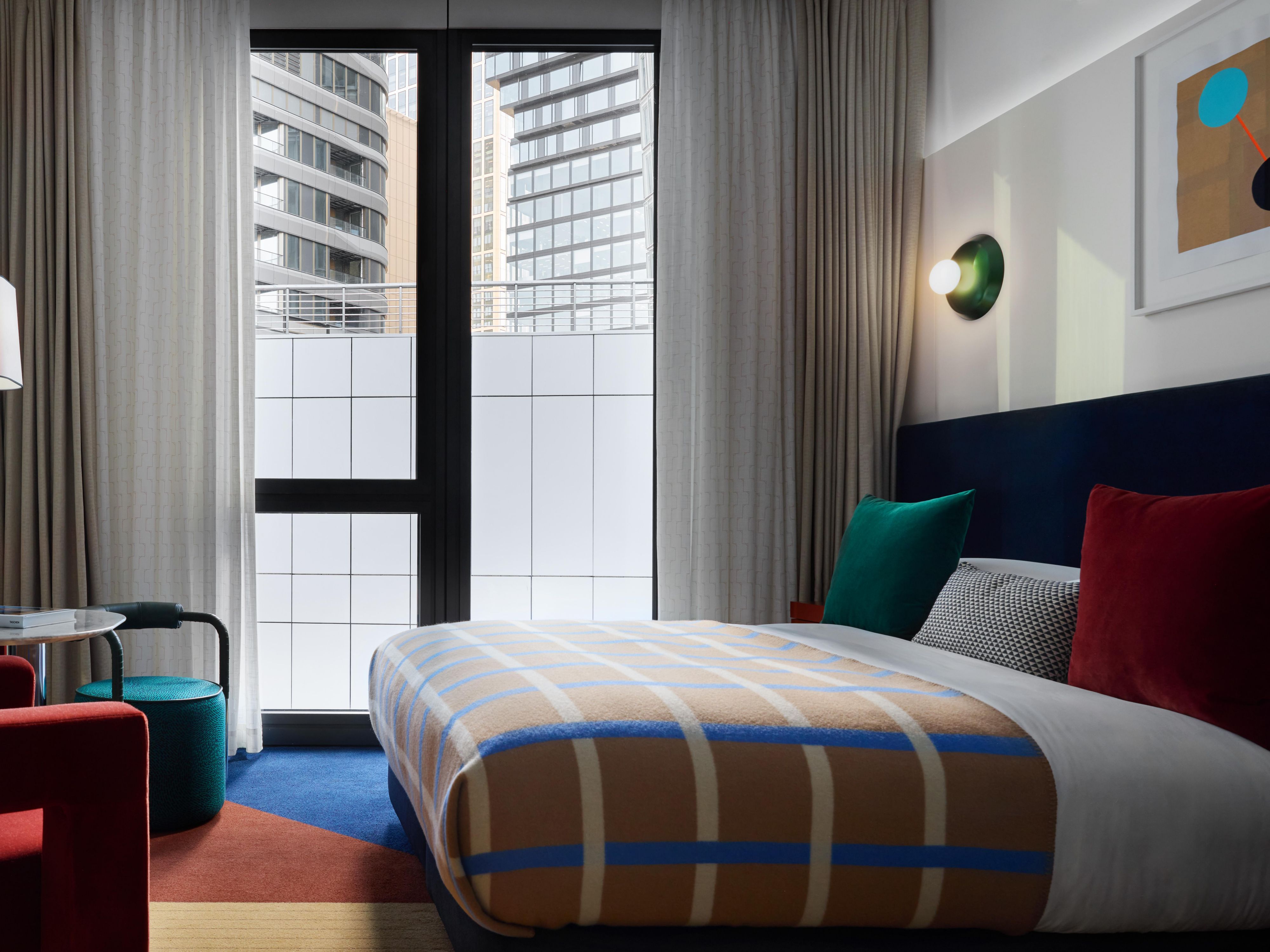 essential room with large window and cosy bed
