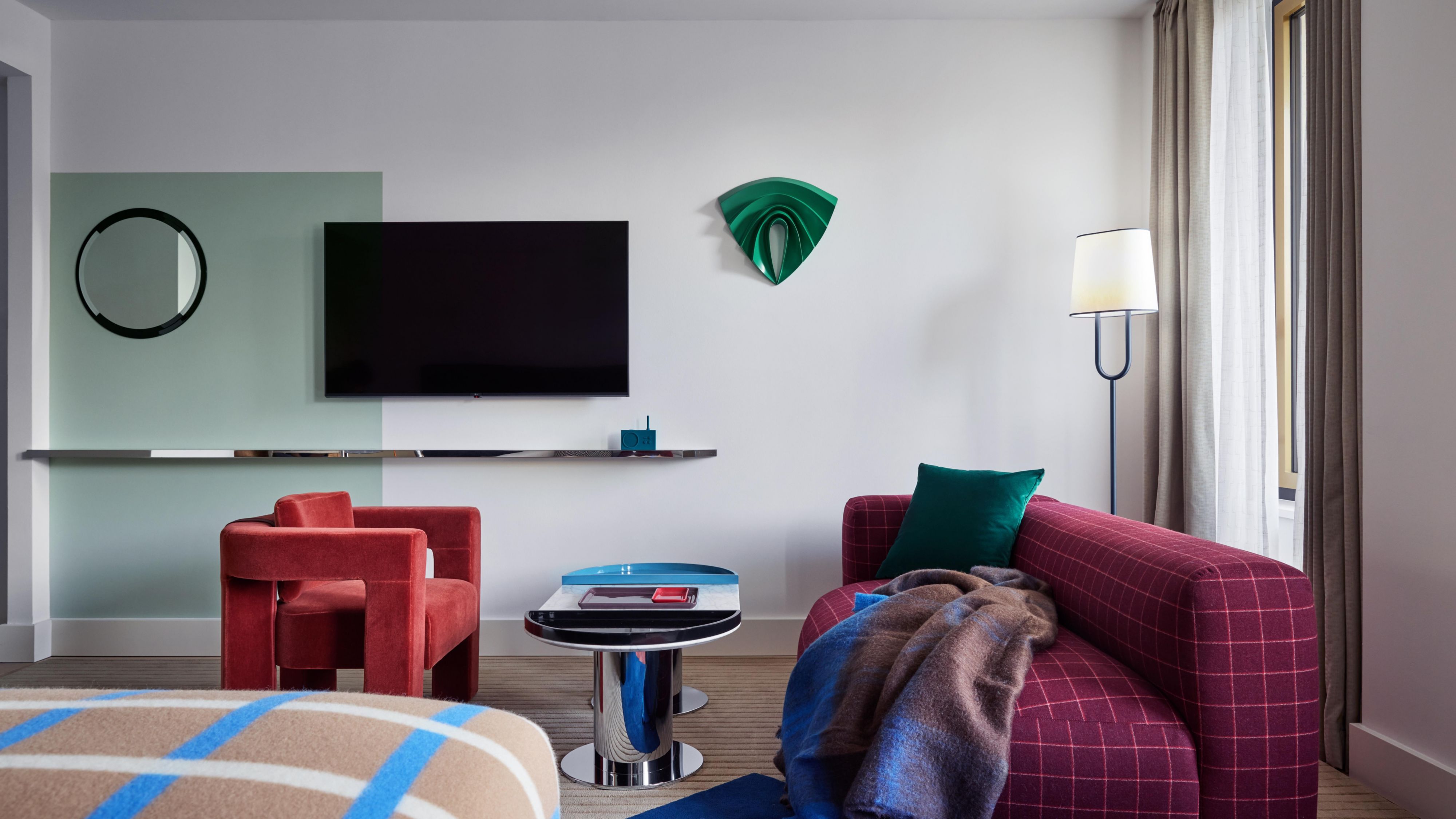 Smart TV and seating area in a luxury hotel guest bedroom