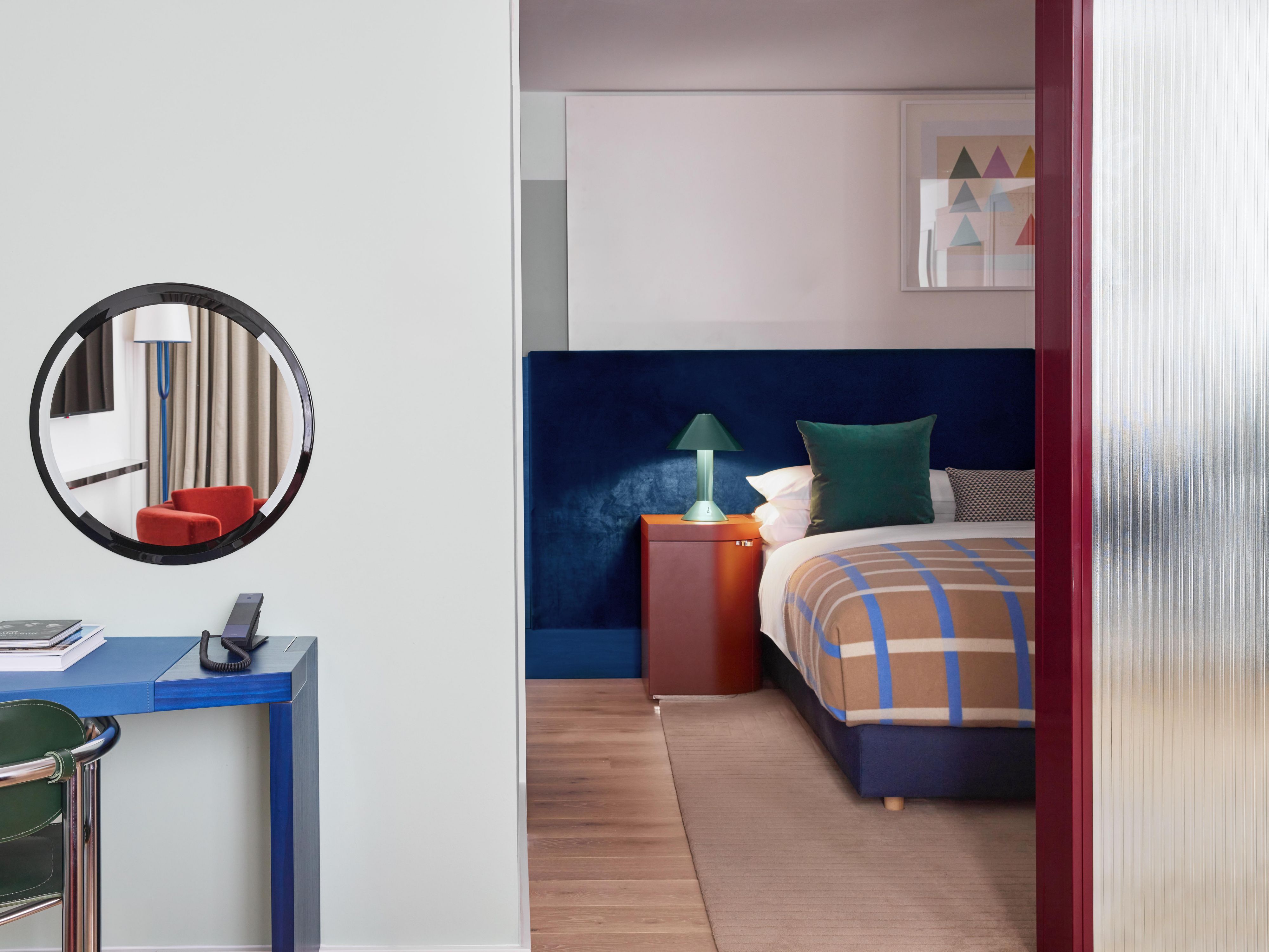 studio suite featuring a plush bed and additonal amenities