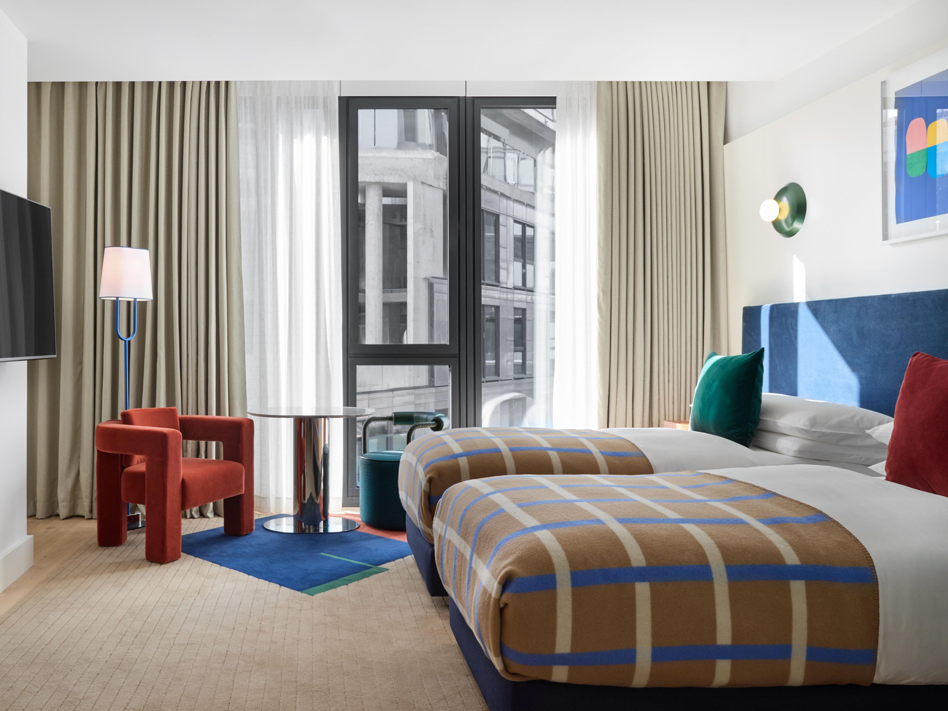 large room with two double beds and a large window