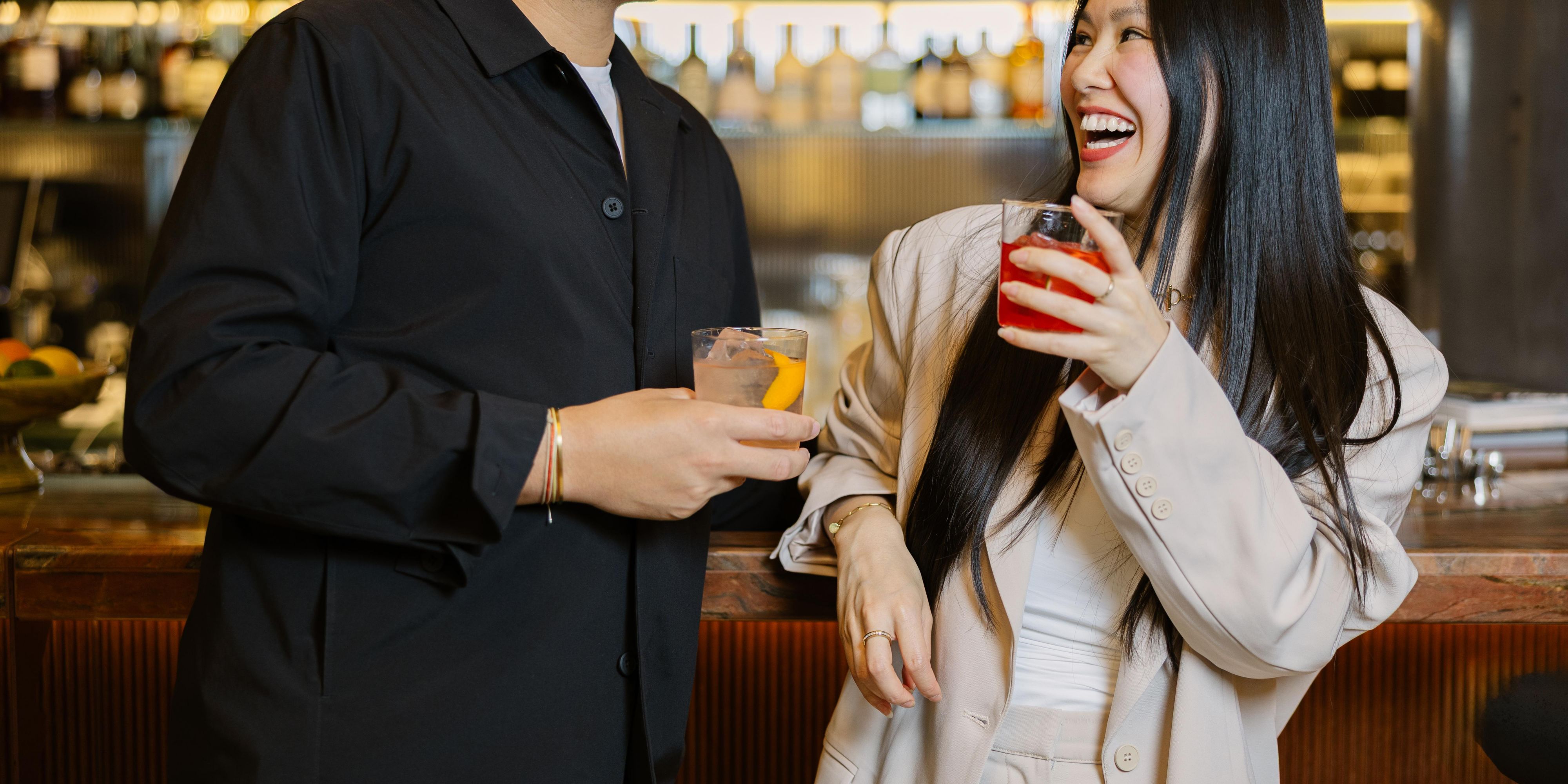 Couple drinking and laughing at May cocktail bar in Frankfurt