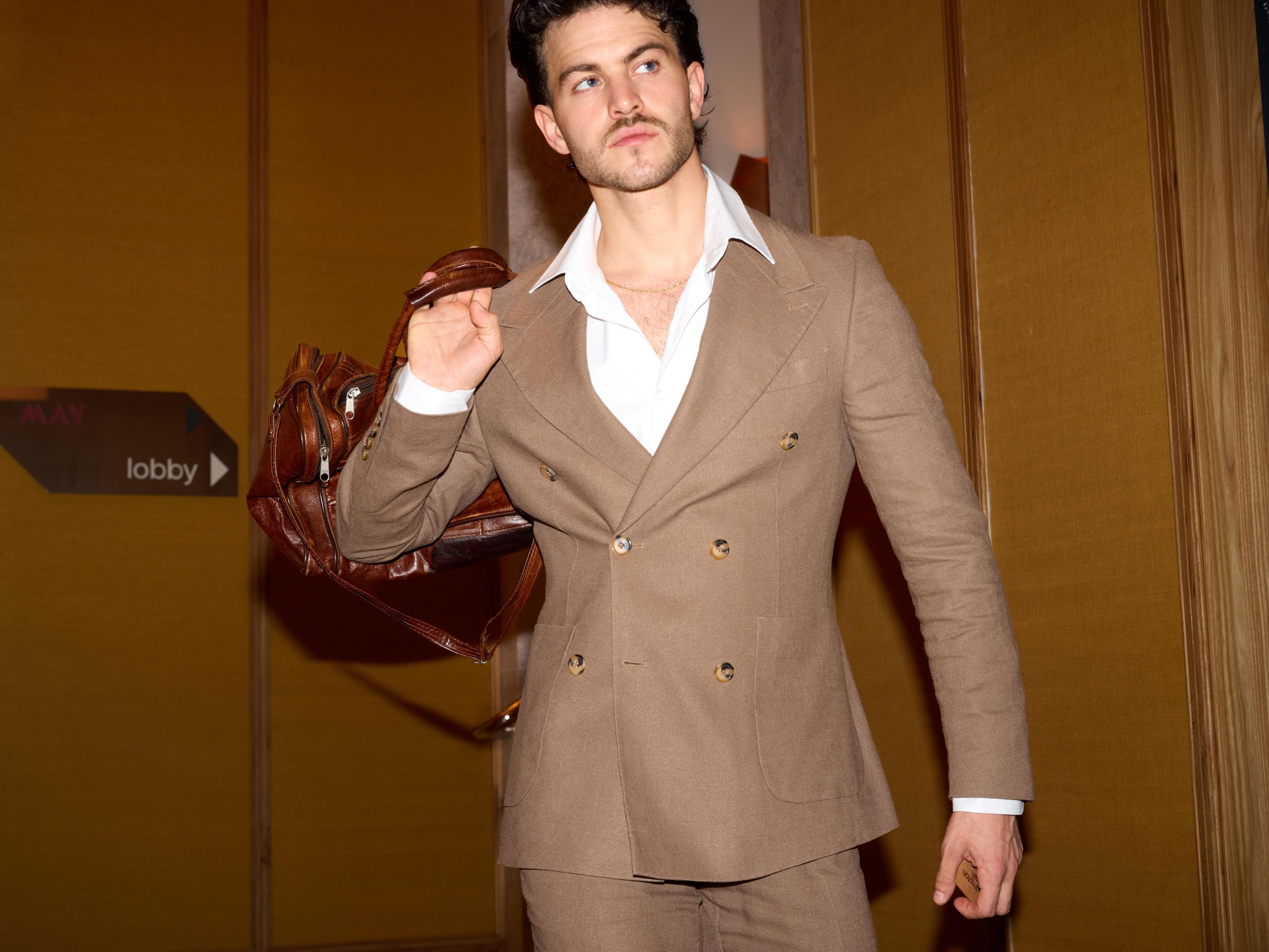 man in suit holding a bag