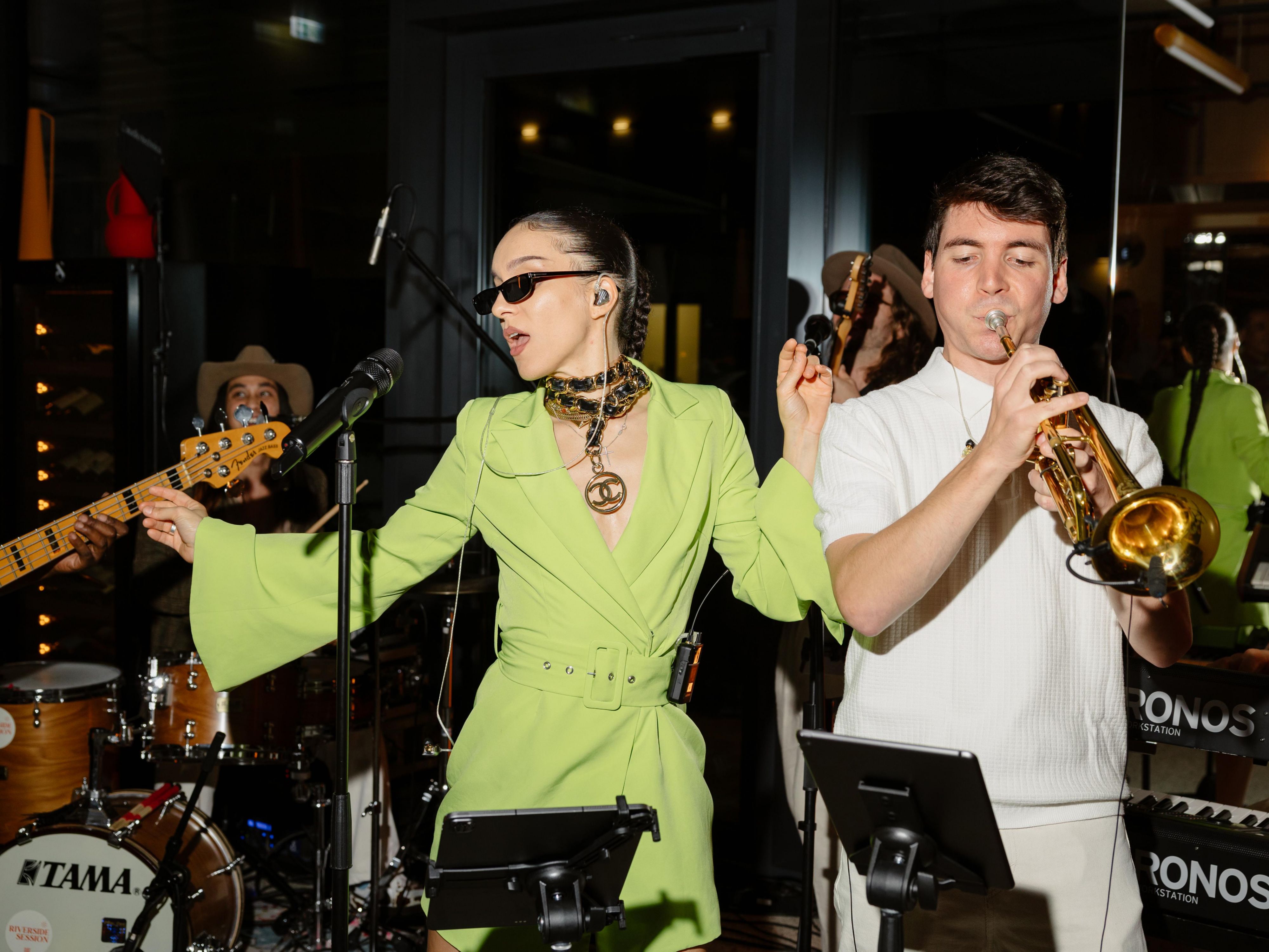 a band performing, singing, and smlining