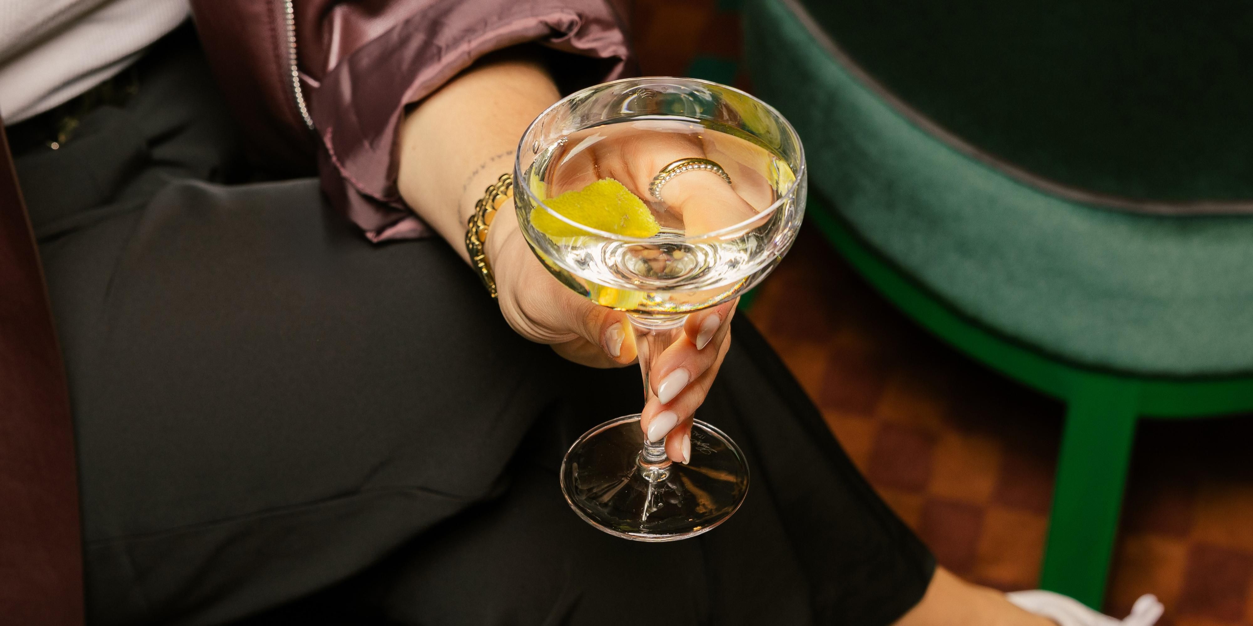 woman holding a martini