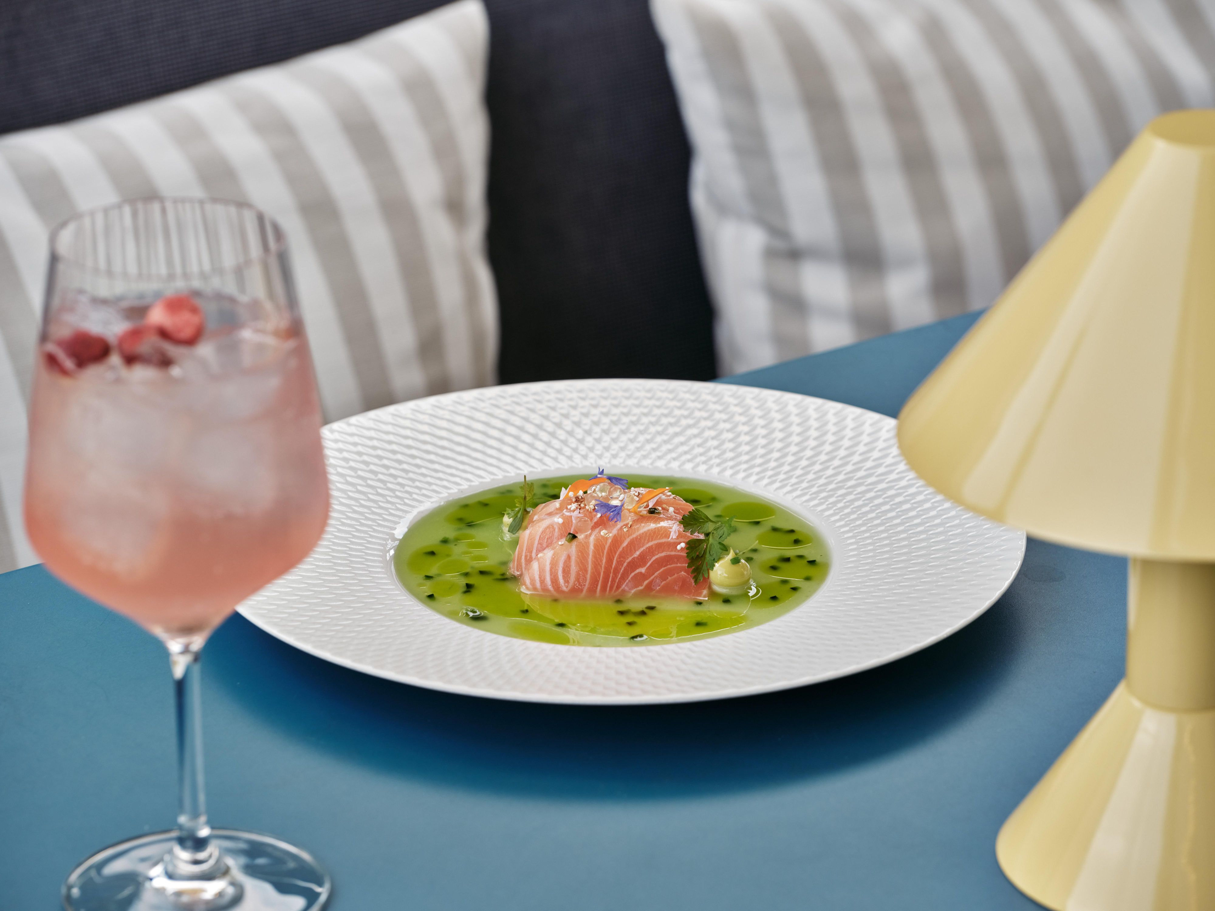salmon dish with a pink spritz