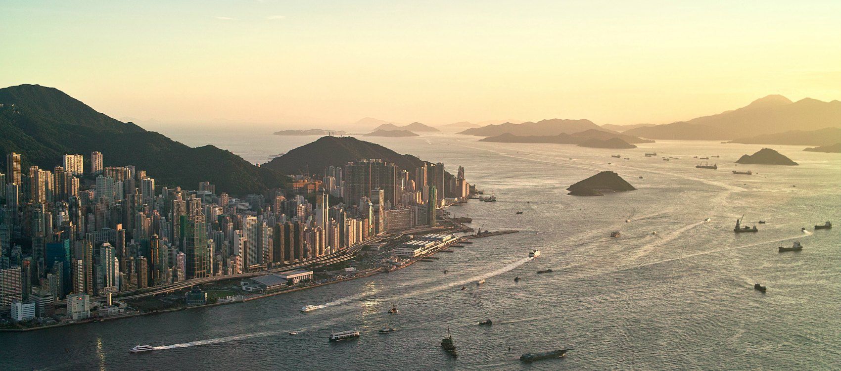 aerial view of hong kong's skyline with boats and islands in background
