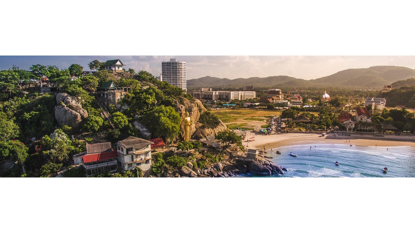 From the ocean, a view of lush island in thailand with dramatic terrain