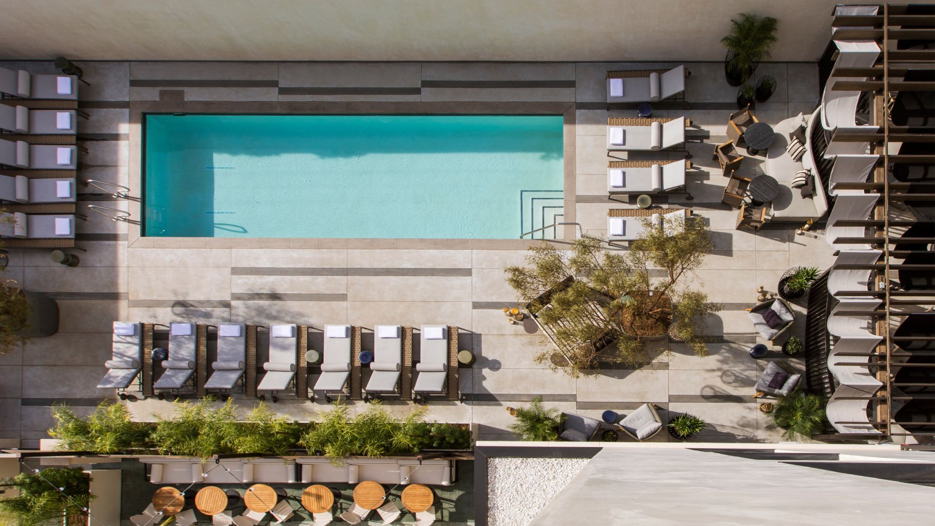 view of a swimming pool surrounded by lounge chairs in los angeles