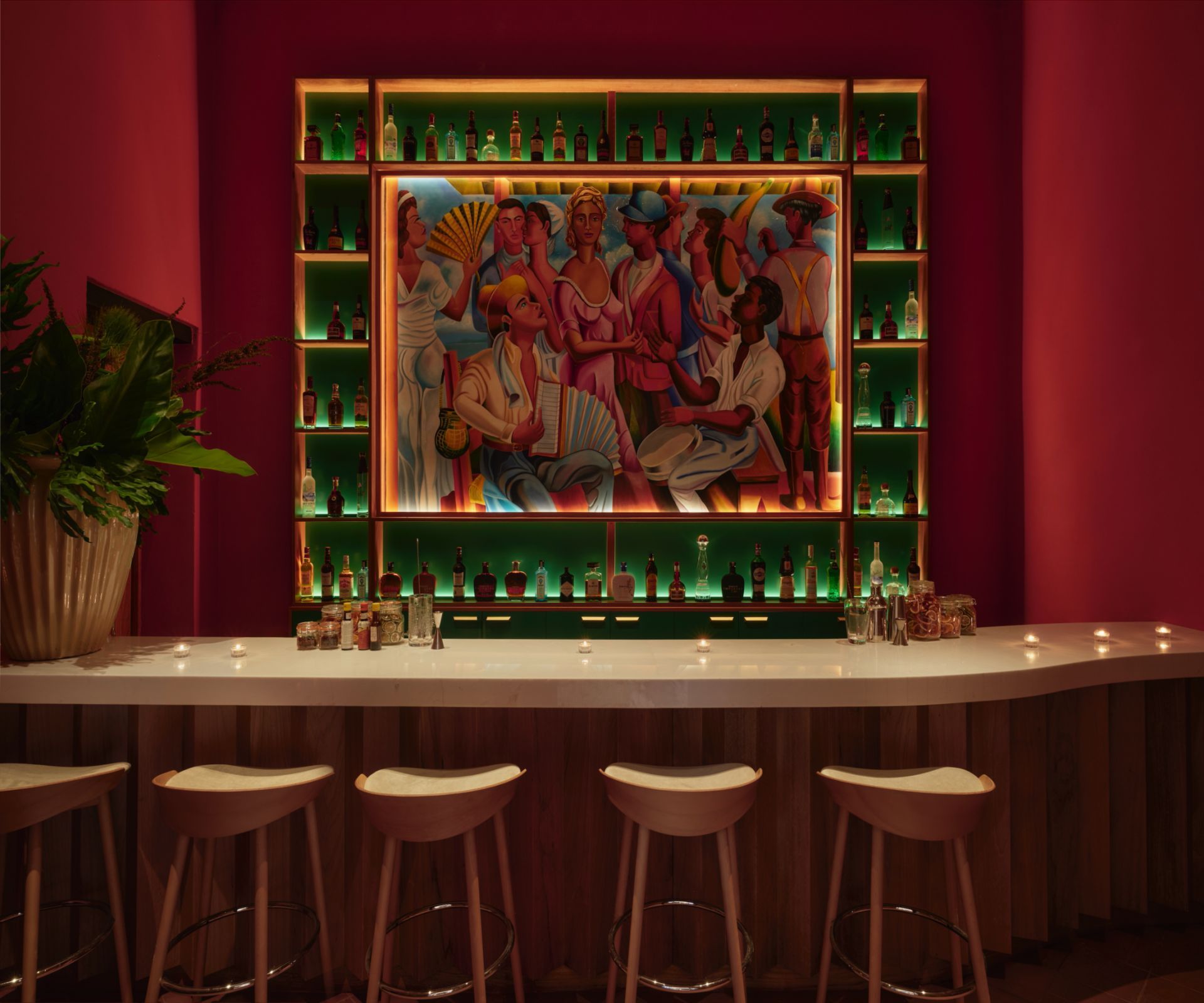 Three beautiful cocktails with colorful garnishes on an outdoor bartop