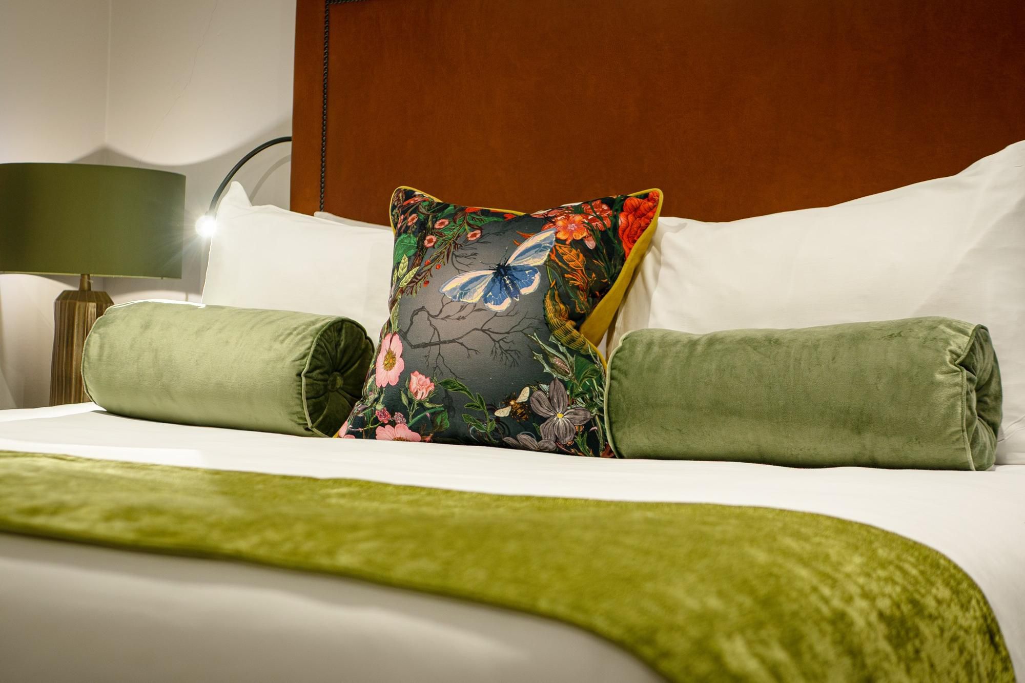 Duplex King Suite, close up of king bed with designer cushion