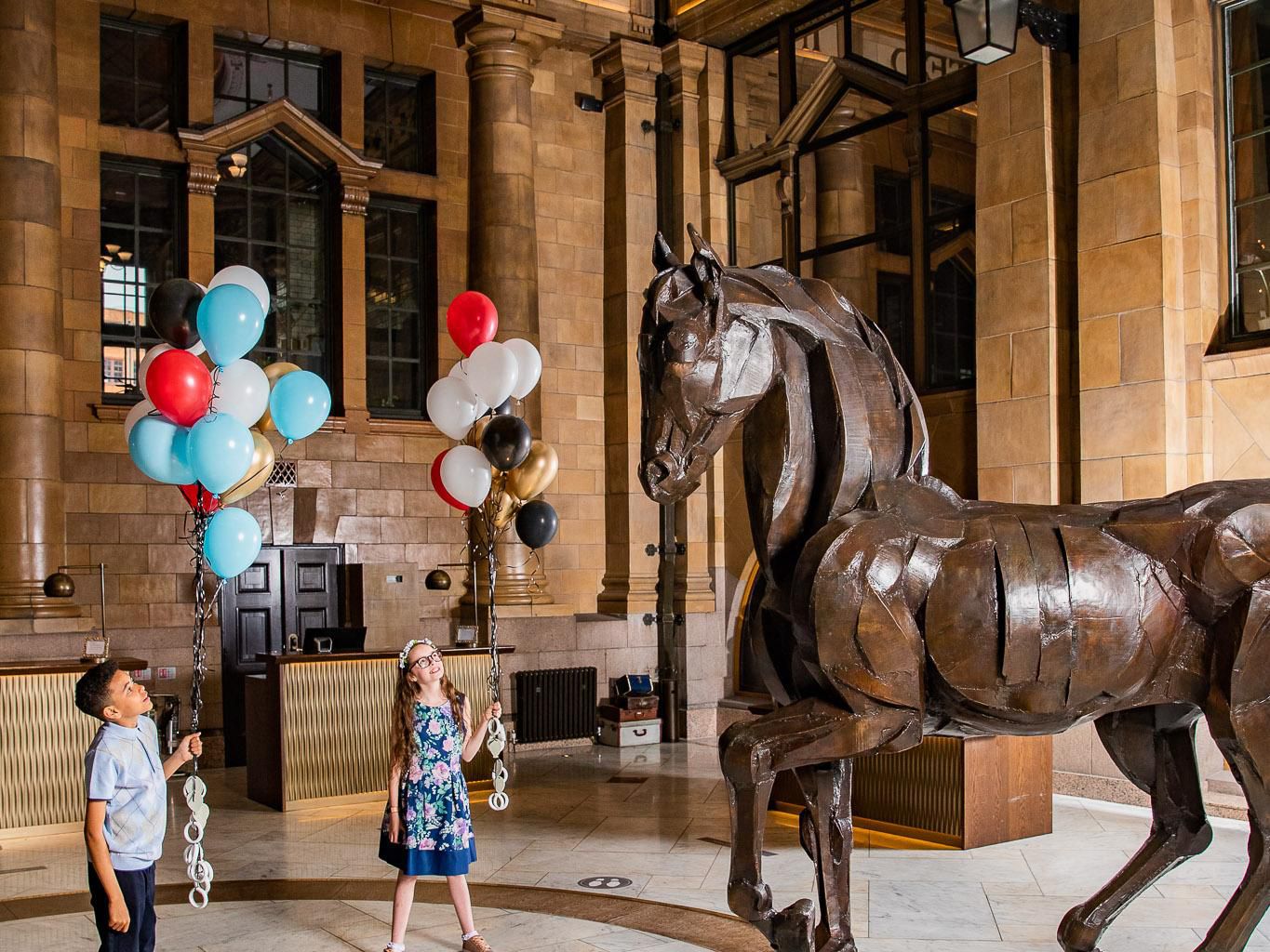 Children in hotel lobby with balloons