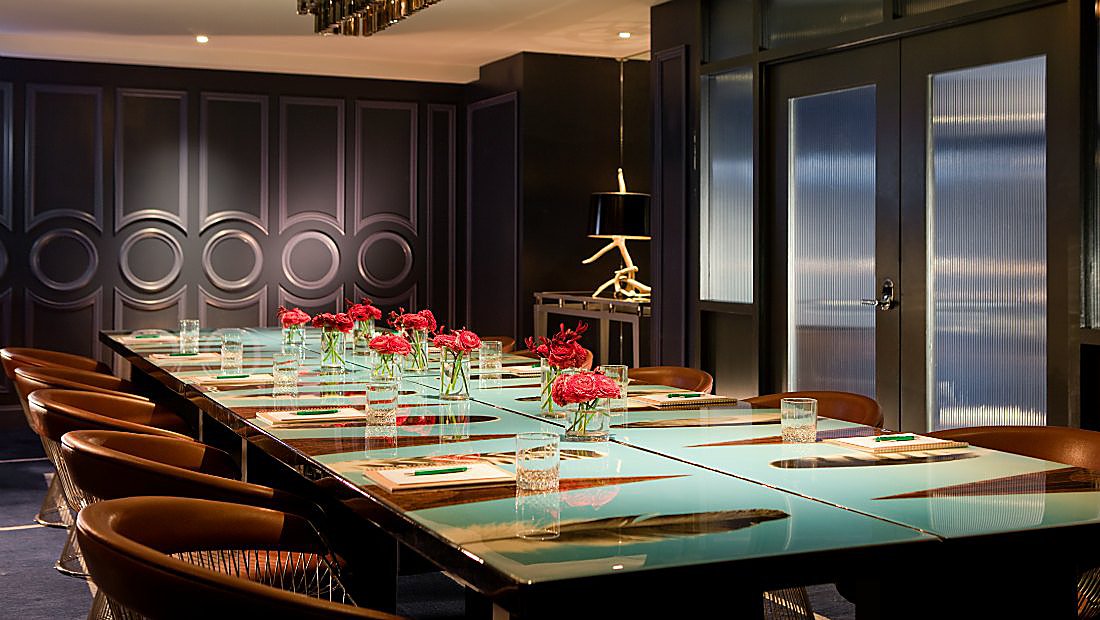Dark meeting room with large feather design on table