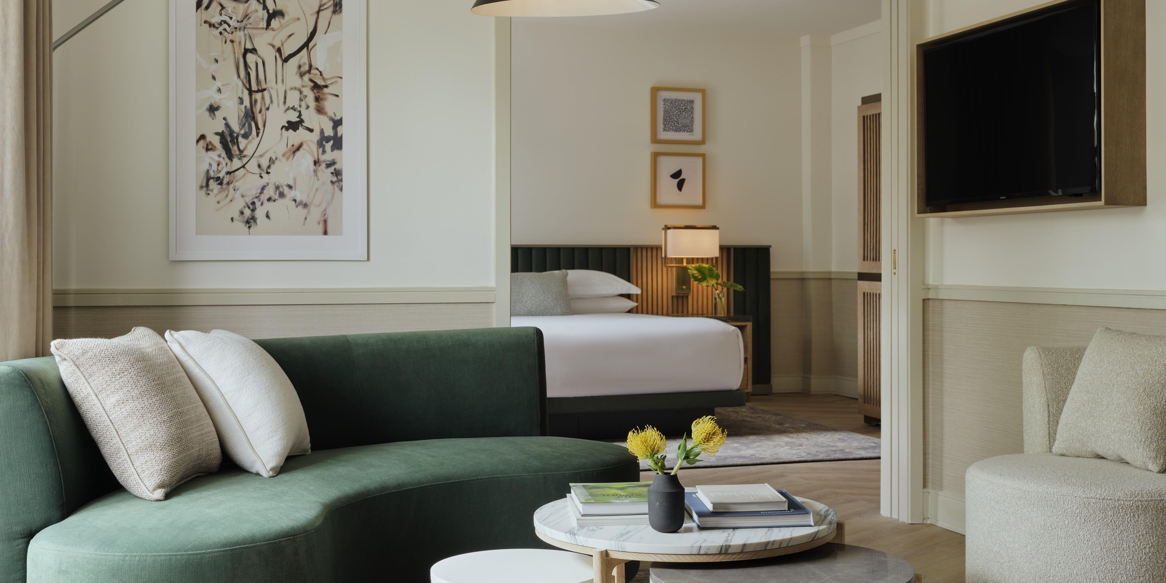 Modern hotel suite with chic lounge and serene bedroom
