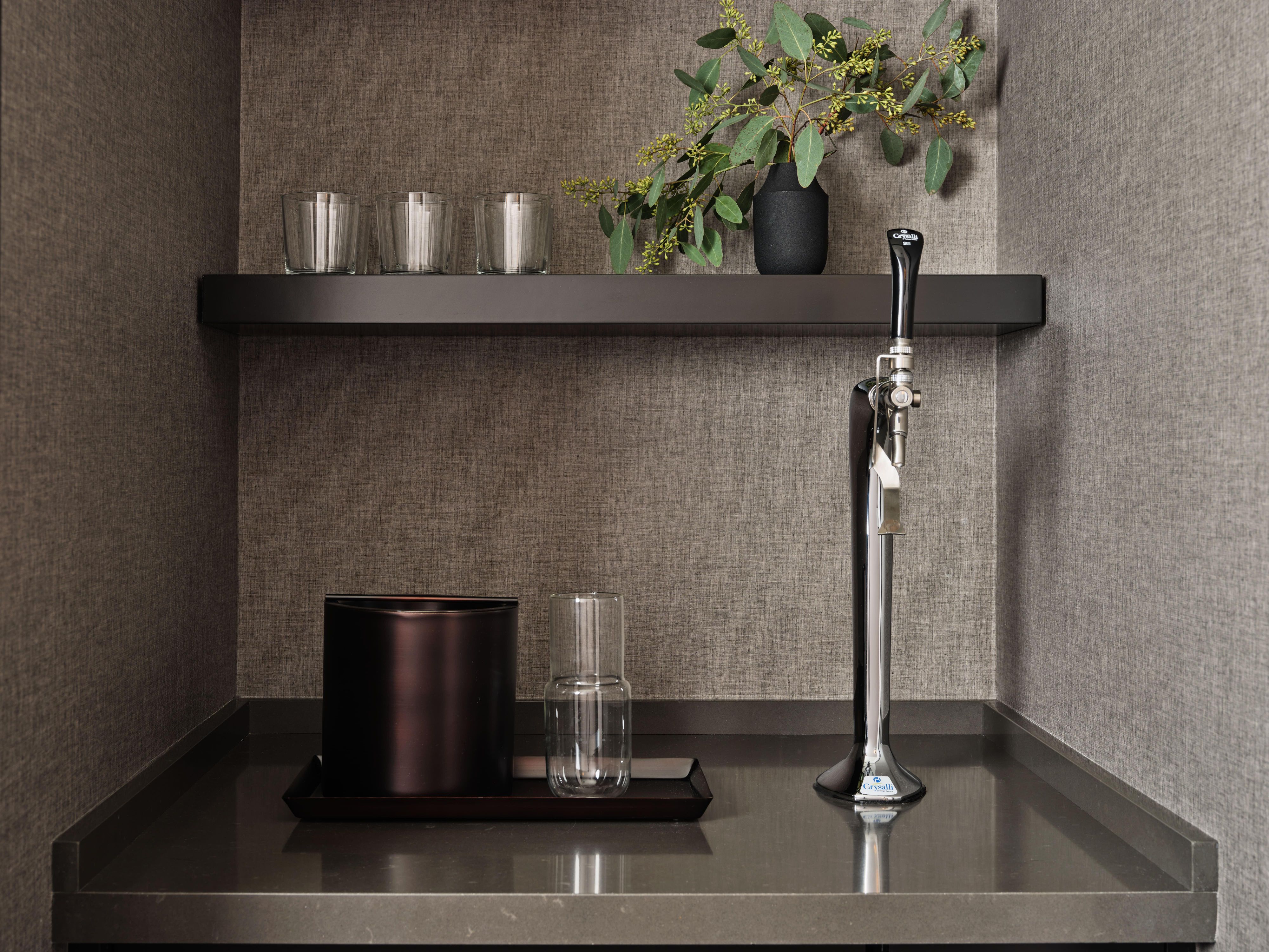 Water refill station with glassware in hotel interior