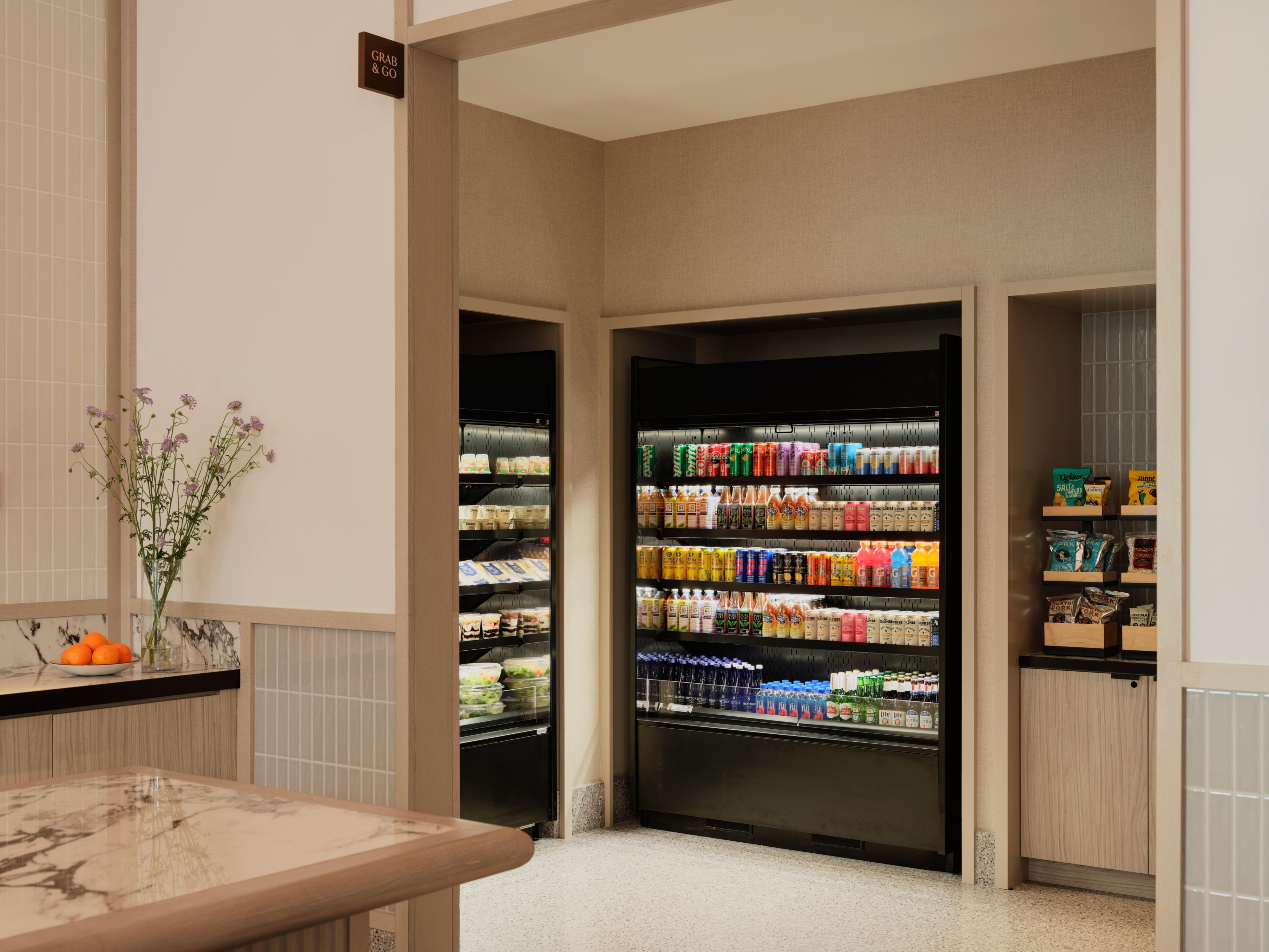 Grab‑and‑go market with refrigerated beverages in hotel