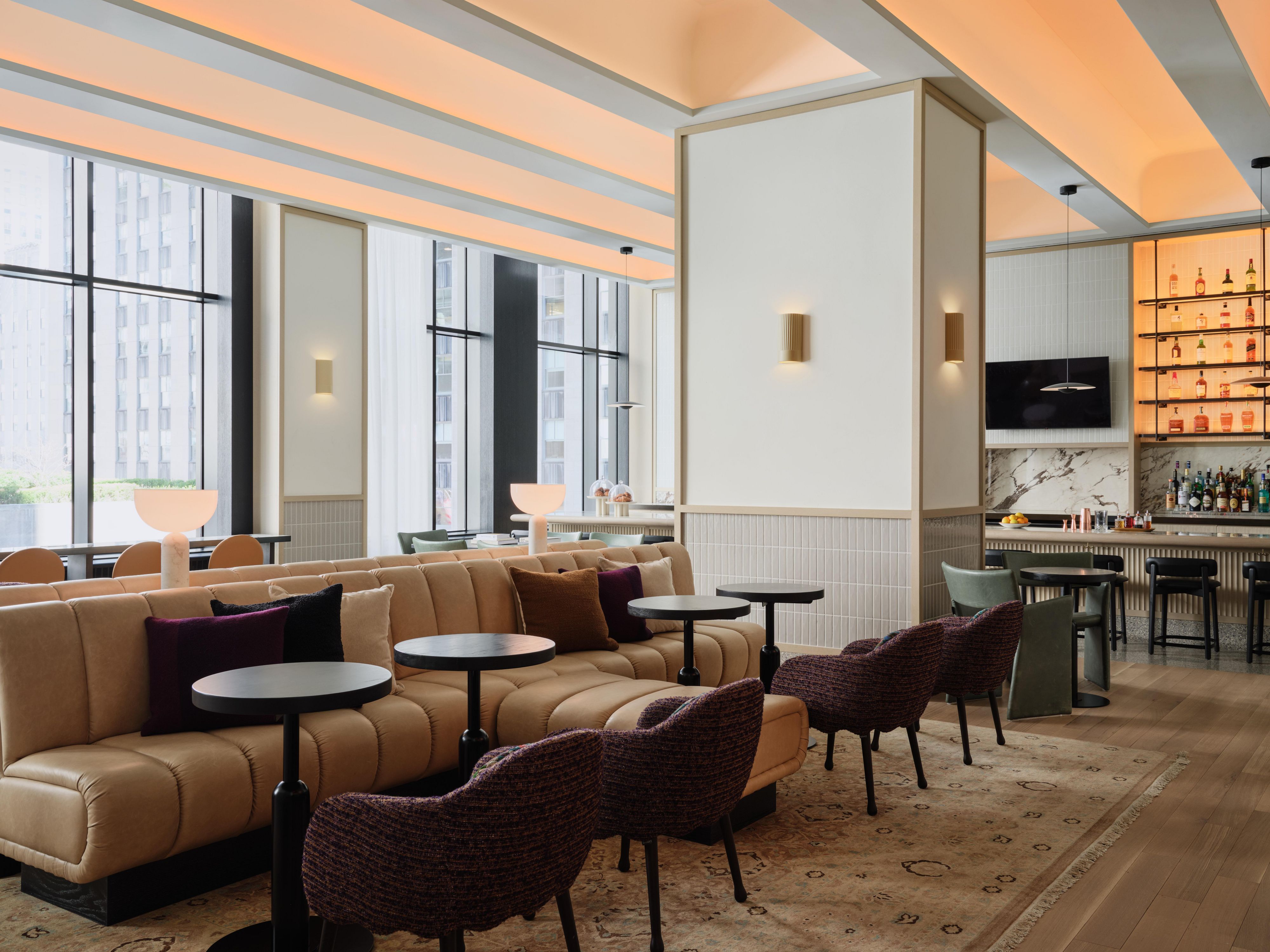 The Parlor lobby lounge with seating and bar in hotel