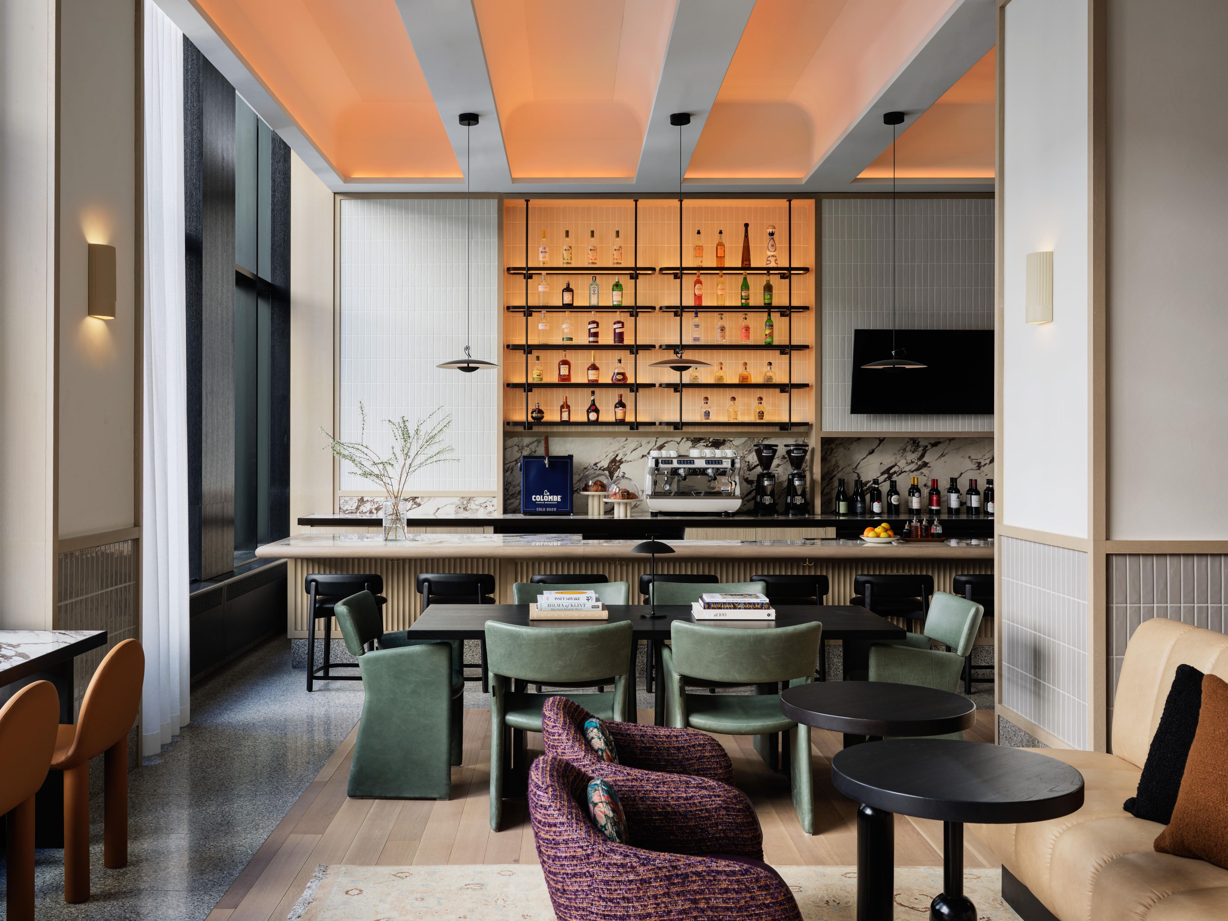 The Parlor lobby bar with tables, chairs, and bar area