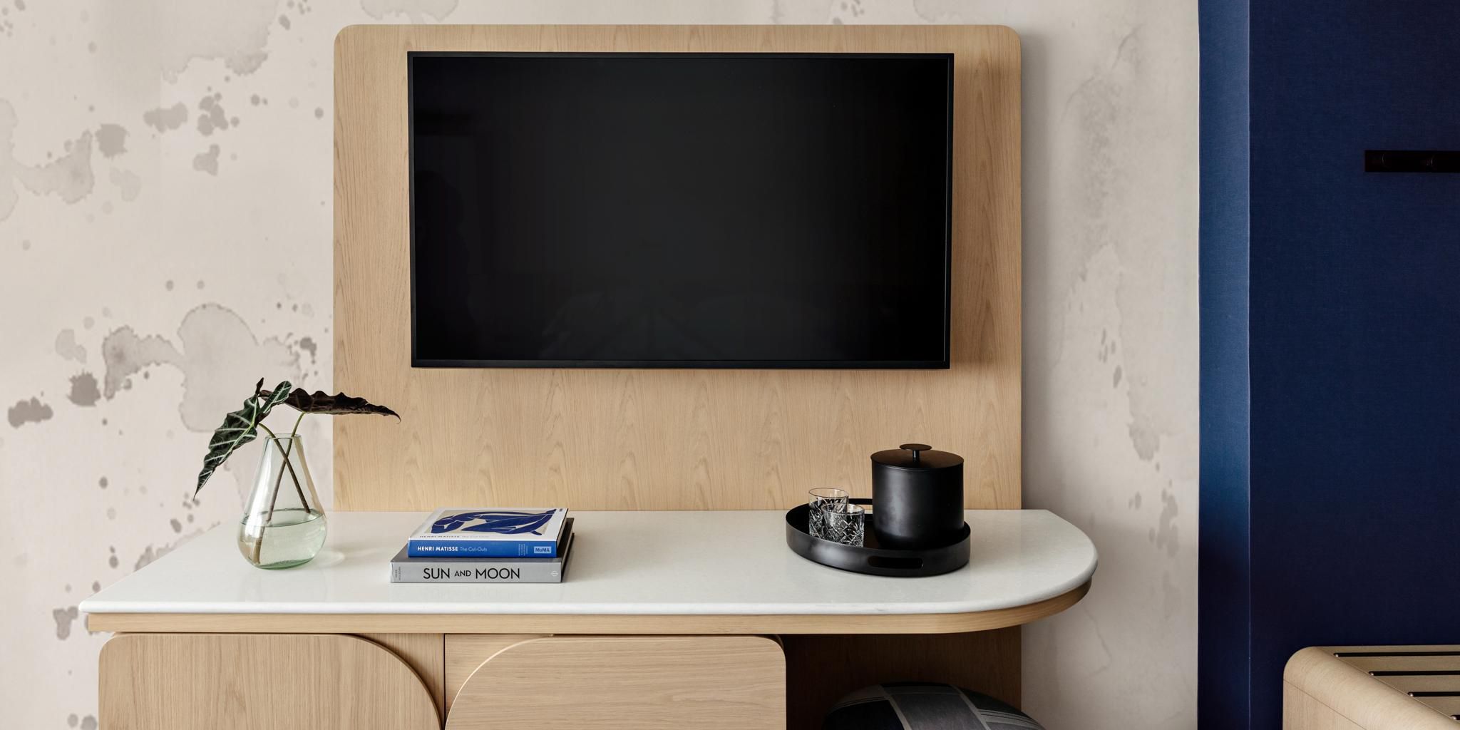 Modern hotel room with wall-mounted TV