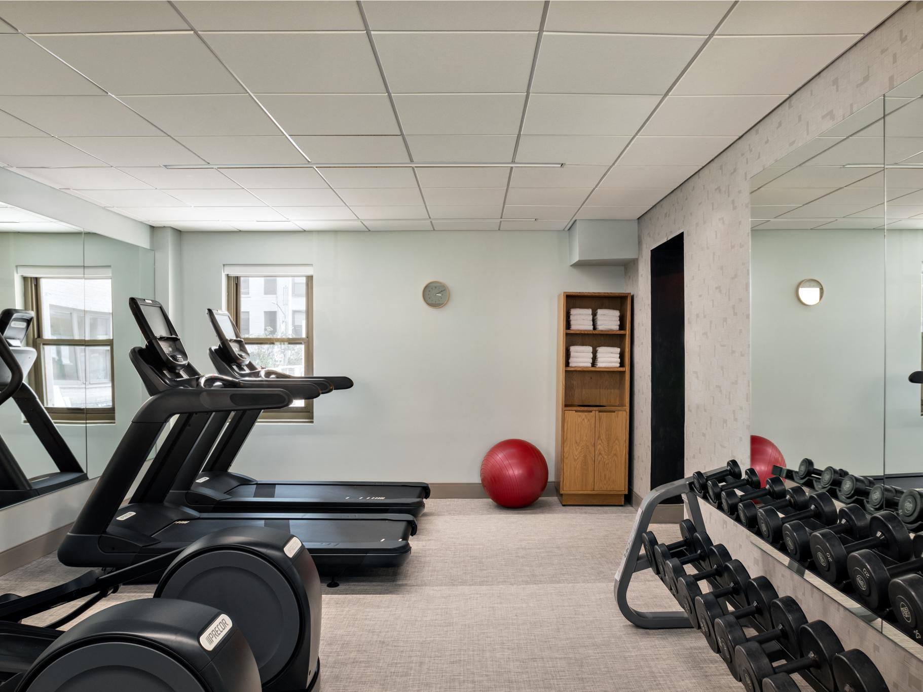 Hotel gym with cardio machines and free weights