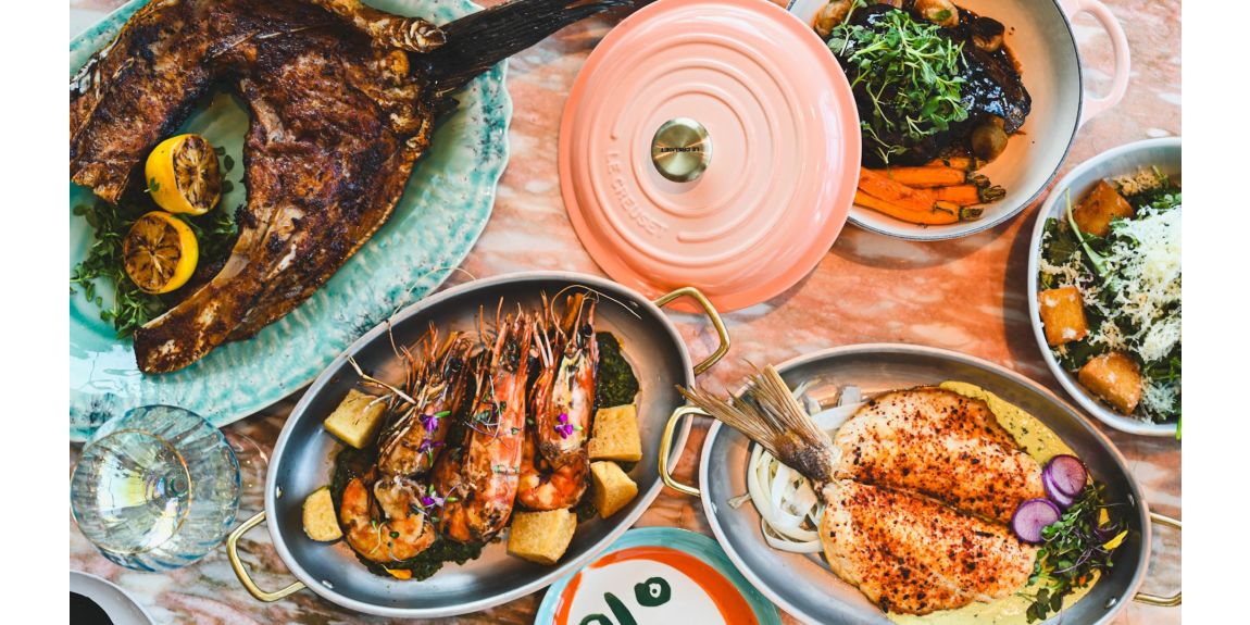 Table with 5 dishes of colorful gourmet entrees