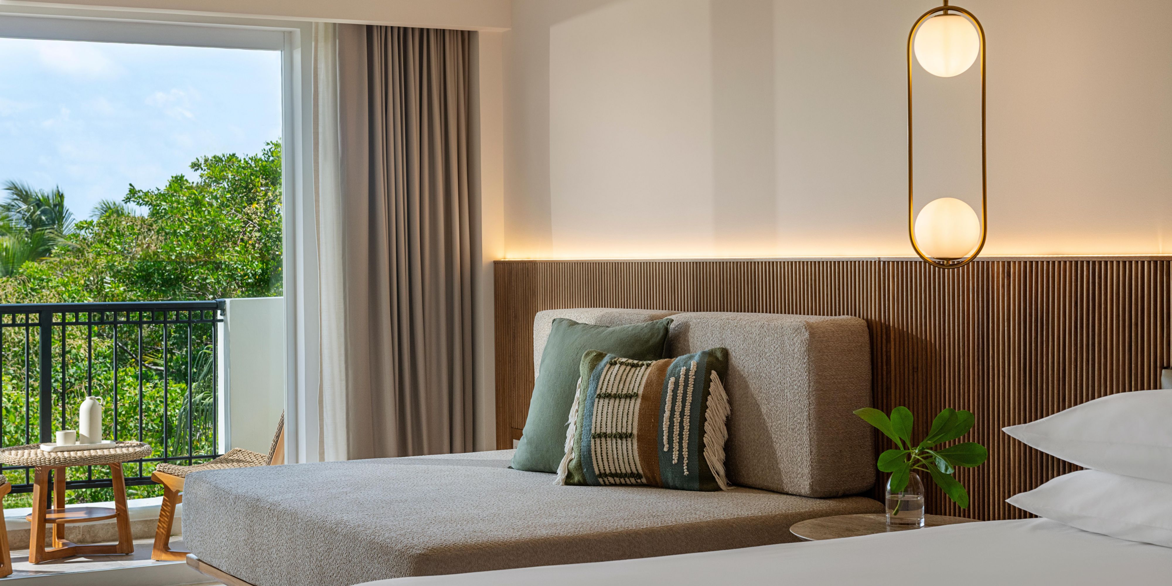 King guest room with balcony and tropical views