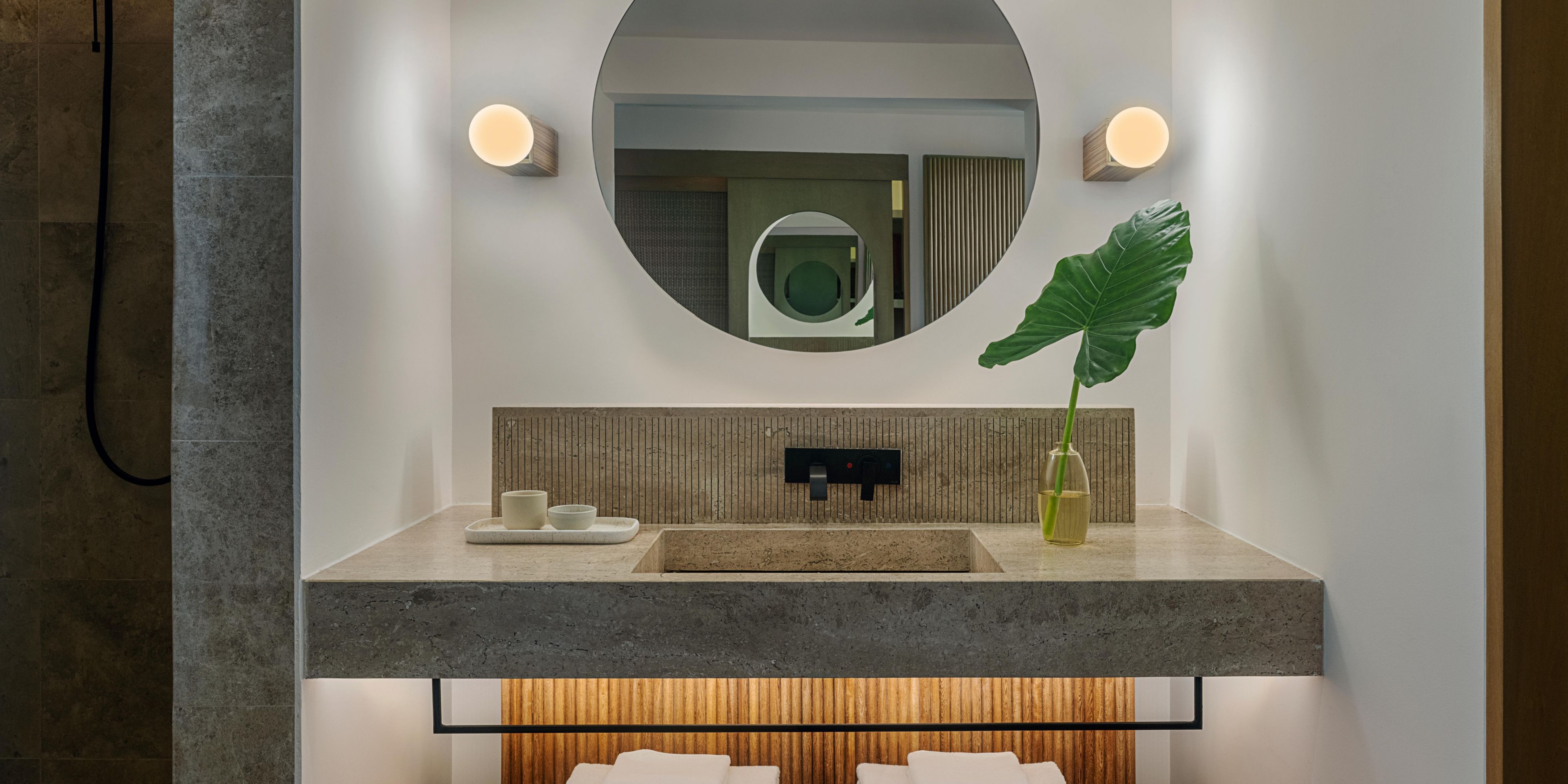 Modern bathroom with double vanity and round mirror
