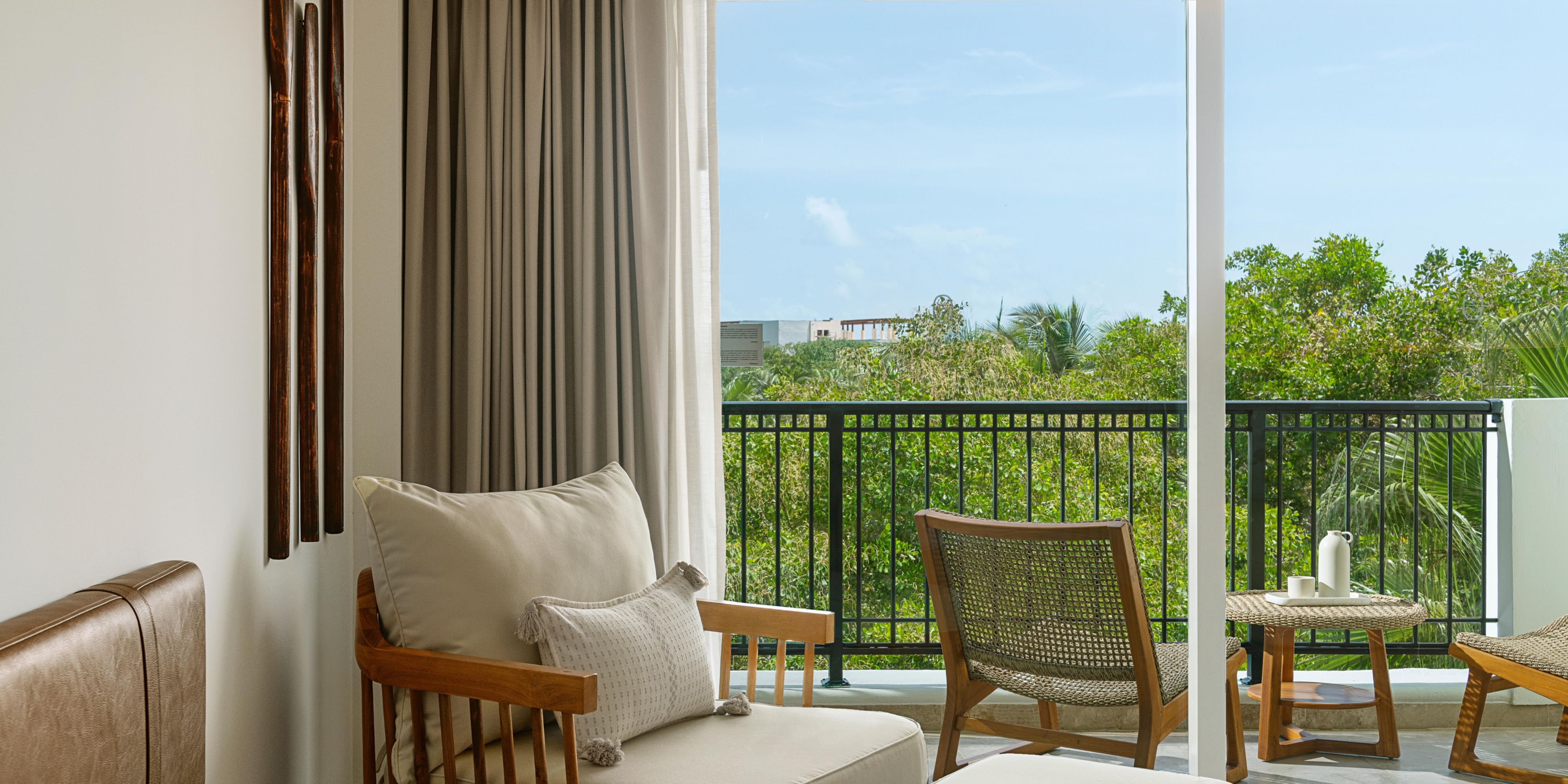 Private balcony with lounge seating and tropical views