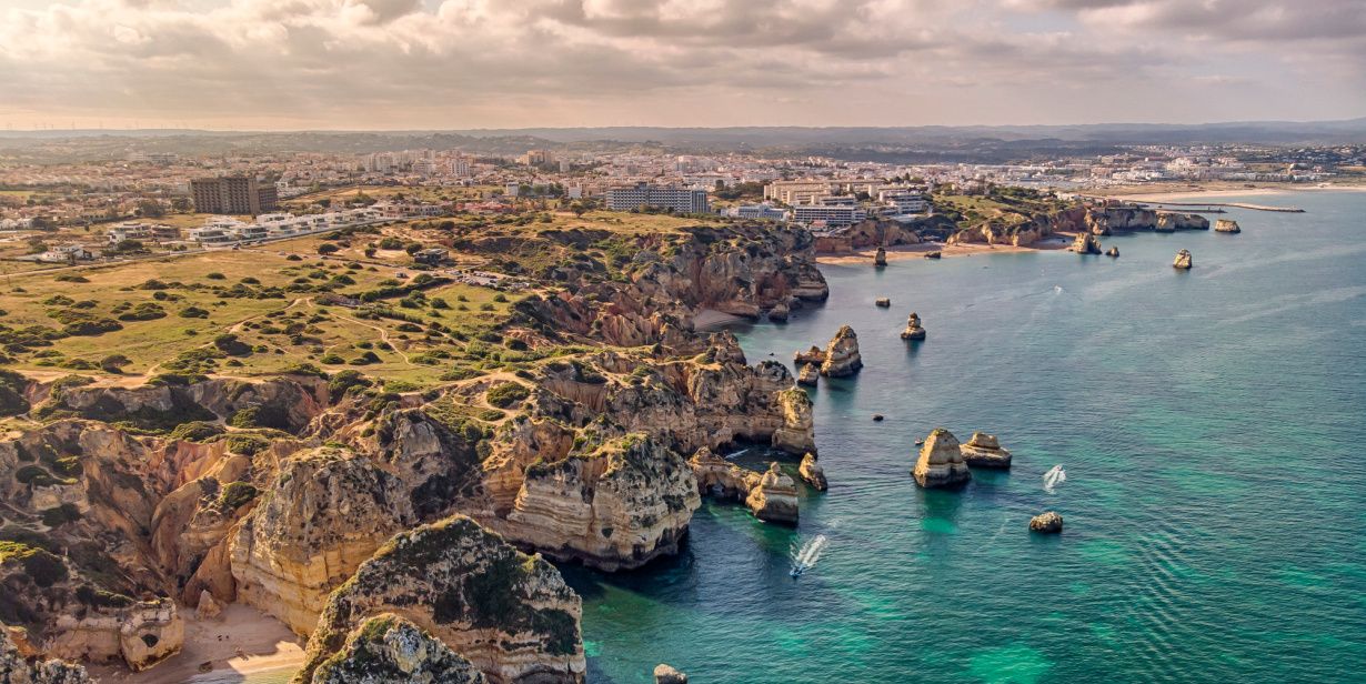 rugged coastline and aerial view of algarve, portugal and ocean