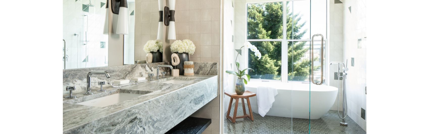 white marble bathroom with flowers on the vanity and freestanding bathtub