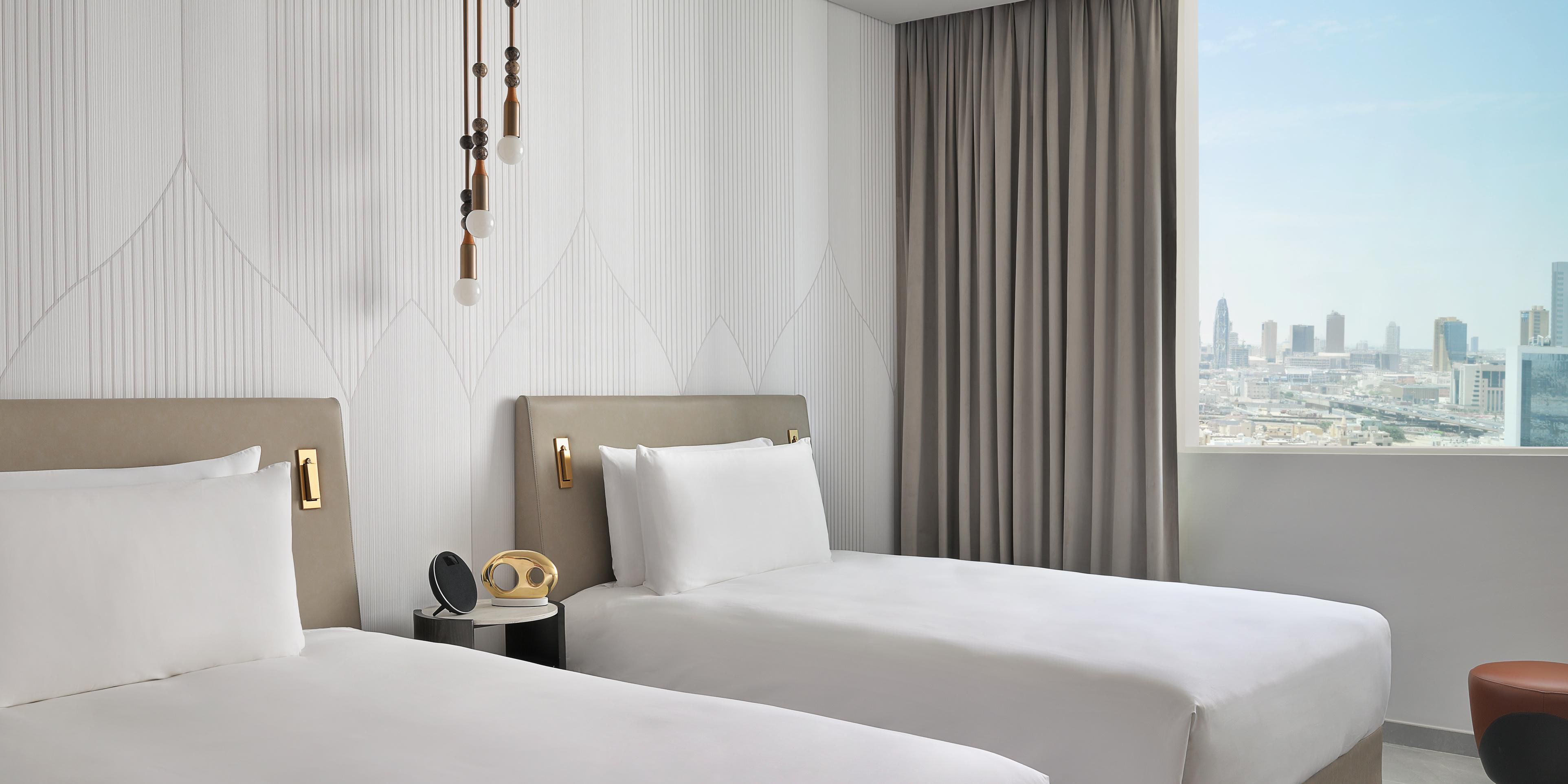Twin room panoramic city views, sleek interiors, natural light