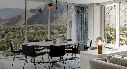 suite with floor to ceiling windows overlooking the mountain range in palm springs