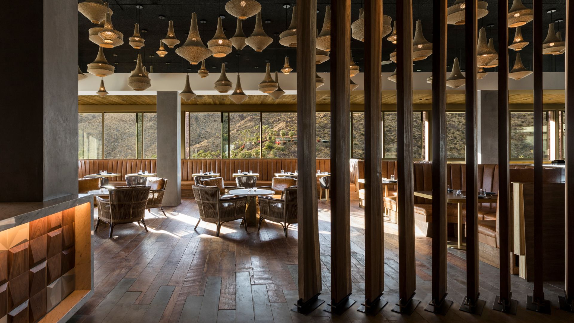 restaurant with wood floors and windows overlooking desert mountains in palm springs