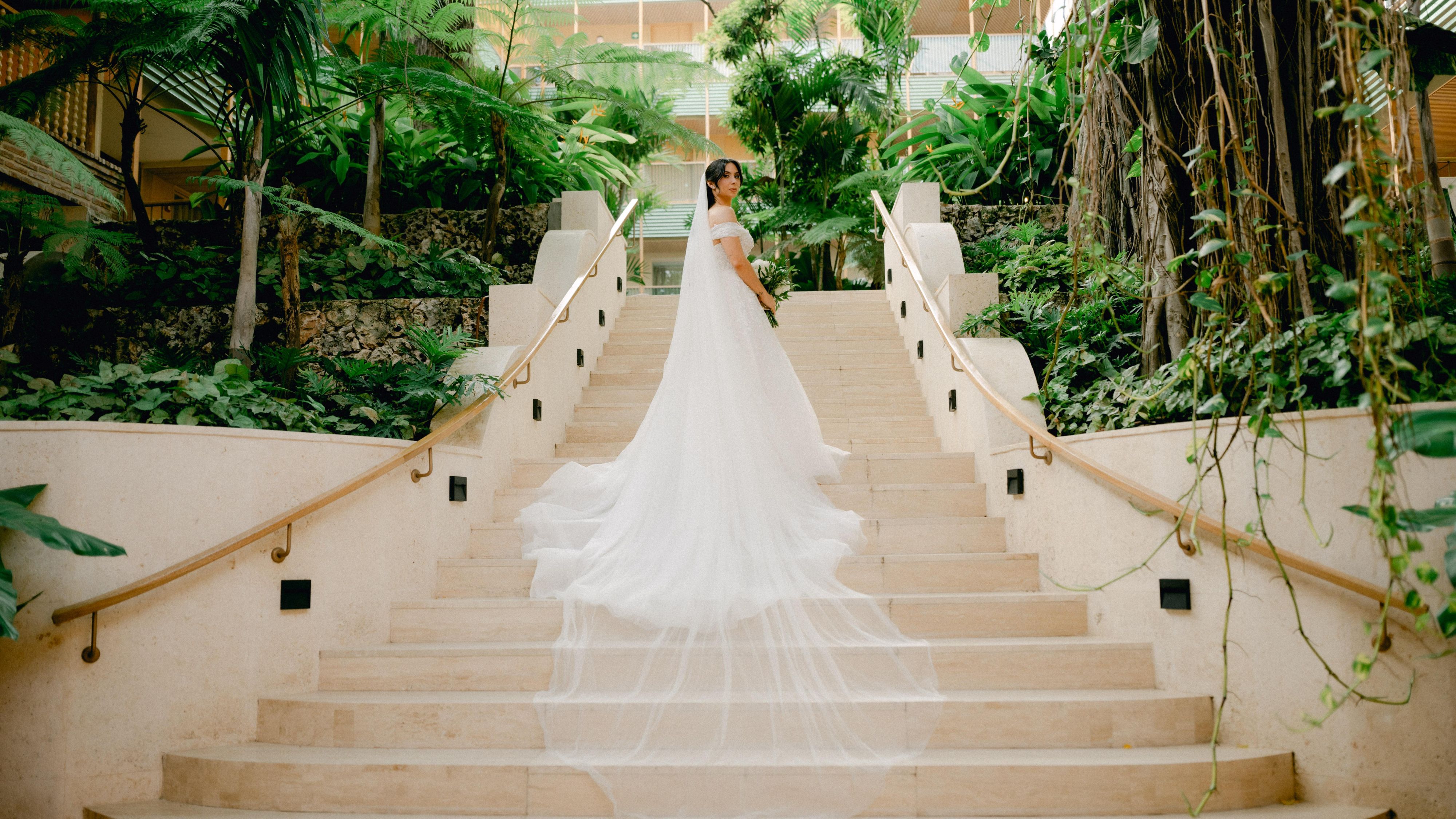 Bride standing posing for a picture on the steps of Kimpton Las Mercedes