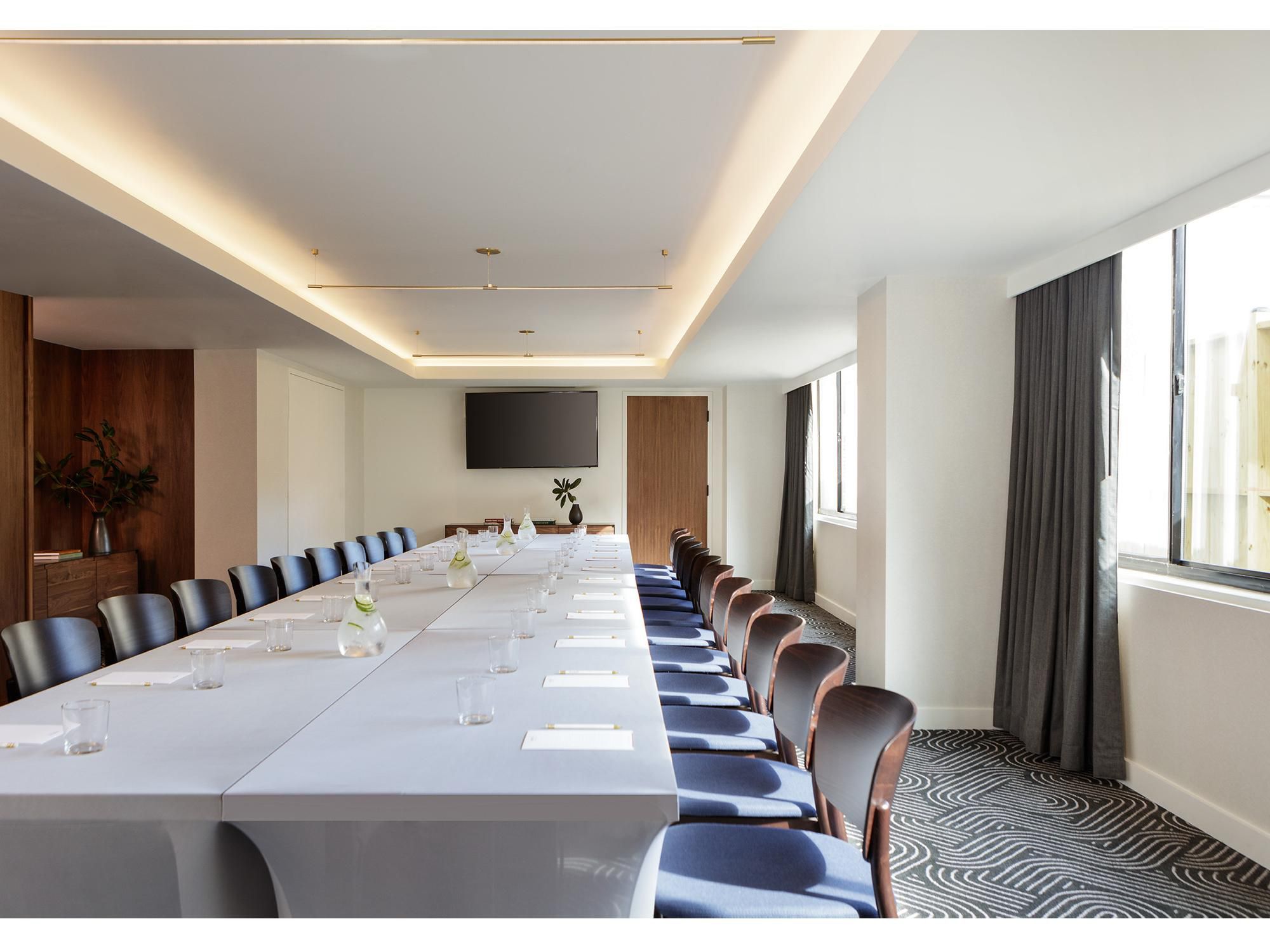 An upscale hotel meeting room with tables around the edges