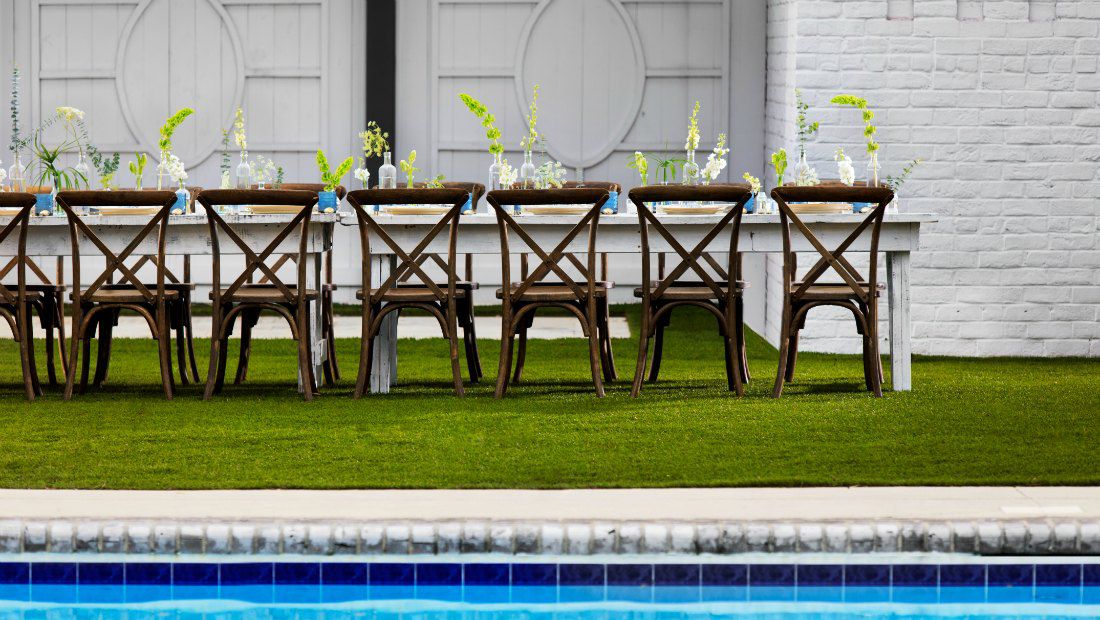 an outdoor dining area beside a pool